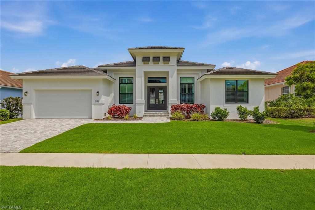 Completed in 2024 by renowned FCI Homes, this exceptional new construction St. Bart model showcases modern coastal luxury, quality craftsmanship and an unbeatable Marco Island waterfront lifestyle. Boating enthusiasts will appreciate the brand-new seawall and dock with a lift, while inside, elegant design, thoughtful upgrades and custom designer curtains throughout create a refined yet welcoming atmosphere. Offering four bedrooms plus a den, three and a half baths and an attached two-car garage. Neutral paint tones, recessed lighting and wood-look tile flooring that flows throughout the main living areas enhance the light-filled interiors. The open-concept design creates a seamless connection between indoor and outdoor spaces, perfectly suited for everyday living and entertaining. The kitchen is both stylish and functional, featuring white cabinetry, a tile backsplash, under-cabinet lighting, Samsung stainless steel appliances and a spacious four-seat breakfast bar that serves as a natural gathering place. Adjacent to the kitchen, the dining area is surrounded by large windows adorned with plantation shutters and highlighted by an updated designer light fixture, creating an inviting setting for casual meals or formal dinners. The living room is bright, open and airy, showcasing a coffered ceiling and expansive views of the pool, lanai and canal beyond. Just off the main living area, the den provides a versatile space for a home office, media room or study, complete with French-door entry and abundant natural light. The spacious primary suite serves as a private retreat, featuring large windows with plantation shutters, custom designer curtains, pool and canal views, and two walk-in closets with custom built-in shelving. The luxurious primary bath offers dual vanities, a large walk-in shower and a soaking tub beautifully positioned beneath a picture window. One guest bedroom enjoys pool and water views and features direct access to a private bath, creating an ideal guest retreat. Two additional guest bedrooms share a well-appointed bath, providing comfortable accommodations for family and visitors. Outdoor living is designed to embrace the waterfront setting, offering a heated pool and spa, multiple seating and dining areas, and a fully equipped outdoor kitchen for effortless entertaining. The brand-new dock, lift and seawall create an exceptional waterfront experience, offering immediate enjoyment for boating enthusiasts and convenient Gulf access. A spacious laundry room features an LG front-load washer and dryer, upper cabinetry, countertop workspace and utility sink, while a conveniently located half bath sits directly across the hall. Combining 2024 construction, premium boating access, southern exposure and an exceptional location near the beach, this waterfront residence presents an outstanding opportunity to enjoy the very best of Marco Island living.