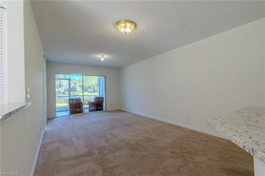 One or more photo(s) has been virtually staged, AI generated or rendered.  Enjoy effortless Southwest Florida living in this beautifully maintained first-floor 2-bedroom, 2-bath condominium overlooking a tranquil lake. Offering 1,083 square feet of thoughtfully designed living space, this residence features a bright, open layout, spacious living and dining areas, and a screened lanai where you can relax while taking in peaceful water views.

The split-bedroom floor plan provides privacy for both owners and guests, while the well-appointed kitchen offers ample cabinetry and workspace for everyday living. Perfectly situated in North Naples, you'll be just minutes from Mercato, premier shopping, dining, entertainment, golf, and the area's renowned Gulf beaches.

Whether you're searching for a year-round residence, seasonal retreat, or investment property, this condo offers an exceptional opportunity to enjoy the Naples lifestyle at an outstanding value.