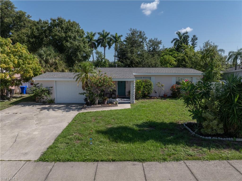 Tucked away in the heart of historic Fort Myers, just off McGregor Boulevard, this enchanting home effortlessly blends modern comfort with classic Florida charm. Every corner has been thoughtfully refreshed, featuring wood-look tile flooring, newer kitchen cabinetry with gleaming granite countertops, stainless steel appliances, recessed lighting, a beautifully updated subway tile shower, newer fixtures and ceiling fans, and so much more. Even the laundry room feels special, complete with custom built-ins and charming sliding barn doors. Outside, the spacious lanai sets the stage for memorable gatherings with a wet bar, mini refrigerator, and warm bistro lighting that creates the perfect evening ambiance. Full of character, style, and thoughtful details, this delightful home is ready to welcome you.