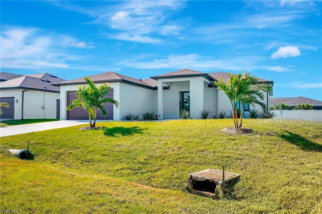 Welcome to your piece of Southwest Florida paradise! Built in 2024 and situated on a double lot, this beautifully designed 3-bedroom, 2-bath residence offers the perfect combination of modern style, quality construction, and an exceptional Cape Coral location. From the moment you arrive, you'll appreciate the clean architectural lines and attractive curb appeal. Step inside and discover an open-concept floor plan that lives much larger than its 1,440 square feet. Soaring vaulted ceilings, abundant natural light, and large-format tile flooring create an airy, inviting atmosphere throughout the home. The spacious great room flows effortlessly into the kitchen and dining area, making everyday living and entertaining both comfortable and convenient. The stunning kitchen showcases the features today's buyers demand, including white shaker cabinetry, stainless steel appliances, a large center island, pantry storage, and expansive workspace for cooking and gathering with family and friends. The split-bedroom floor plan provides privacy for owners and guests alike. At the same time, the master suite offers a relaxing retreat complete with dual sinks, generous closet space, and a luxurious bath. Built with peace of mind in mind, this home includes impact-resistant windows and doors, concrete block construction, a two-car garage, and a covered lanai overlooking the expansive backyard. The pie-shaped lot provides opportunities rarely found in newer homes and offers ample space for pets, play, gardening, or creating your own backyard oasis. Location is everything, and this home delivers. Positioned in one of Cape Coral's rapidly developing areas just west of Santa Barbara Boulevard and near Burnt Store Road, residents enjoy convenient access to Matlacha, Pine Island, Punta Gorda, Fort Myers, and Southwest Florida International Airport. Shopping, dining, healthcare facilities, golf courses, boating, fishing, and everyday conveniences are all within easy reach. Cape Coral continues to attract buyers from around the country thanks to its extensive canal system, year-round sunshine, affordable lifestyle, and strong growth. Spend weekends exploring nearby Gulf beaches on Sanibel and Captiva Islands, boating through local waterways, enjoying waterfront restaurants, or taking in spring training baseball, live entertainment, farmers markets, and countless outdoor festivals. World-class fishing, kayaking, paddleboarding, golf, nature preserves, and spectacular sunsets are all part of the Southwest Florida lifestyle. Whether you're searching for a full-time residence, seasonal retreat, or investment in one of Florida's most desirable growth markets, this nearly new home offers an outstanding opportunity to enjoy the best of Cape Coral and Southwest Florida living. Schedule your private showing today and experience everything this exceptional property has to offer.