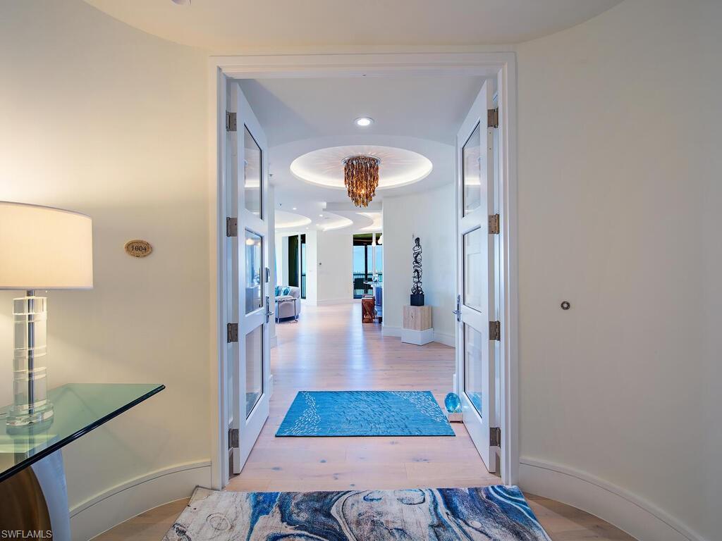 An exceptional opportunity awaits in La Scala at The Colony Golf & Bay Club, a premier 04 residence fully renovated in 2022. This stunning 10th-floor unit offers over 4,260 square feet of interior living space (more than 5,100 square feet including multiple lanais) with spectacular, unobstructed views of Estero Bay and the Gulf of Mexico.

From the moment you step off the private elevator, custom double glass doors welcome you into an elegant foyer, leading to the expansive Great Room framed by floor-to-ceiling windows that showcase breathtaking waterfront vistas. The meticulous renovation includes wide-plank light oak wood floors throughout, complemented by porcelain tile in the five updated bathrooms. The all-new kitchen is a chef’s dream, featuring Wolf and Sub-Zero appliances including double ovens, quartz and back lit quartzite countertops, and custom cabinetry designed for both beauty and functionality.

The primary suite is a serene retreat, complete with a spa-inspired bathroom featuring floating vanities, a freestanding soaking tub, and a luxurious oversized shower. Two additional en-suite bedrooms, located on opposite sides of the unit, offer privacy and comfort for guests. A spacious den adds flexibility, and a total of 4.5 baths ensures convenience. Additional updates include new solid-core 4-panel doors, enhanced baseboards, custom LED lighting throughout, and a fully redesigned laundry room.

La Scala offers an exclusive lifestyle with just 64 residences and world-class amenities. The building features a grand two-story lounge with double marble staircases, a theater, a library, social room with outside terrace and a billiards room. The fitness center, resort-style pool, and spa are generously sized, providing a luxury experience typically found in much larger communities. A 24/7 staffed front desk ensures security and convenience for all residents.

Beyond La Scala, The Colony’s premier amenities elevate the lifestyle further, including waterfront dining at the Bay Club, a private 34-acre island beach park, and optional equity golf memberships at The Colony Golf & Bay Club ( current waiting list). This home combines elegant modern design, sophisticated living, and the unparalleled natural beauty of Southwest Florida, making it an extraordinary opportunity in one of the region’s most prestigious communities.
