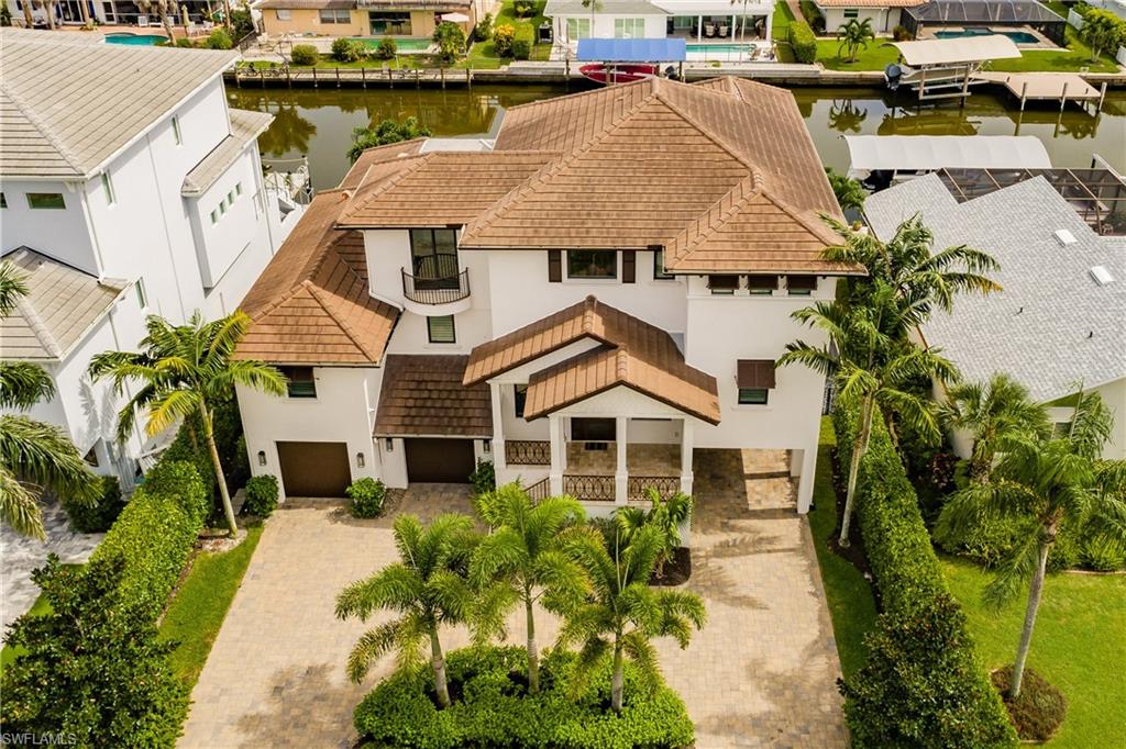 Don't miss out on this 2015 custom built waterfront home available in Conners Vanderbilt Beach.  With 4 bedrooms + den, 3 full baths, 5 car garage, elevator, and 3649 square feet of living space and 7254 total square feet, this Coastal Transitional residence is filled with exceptional finishes throughout, shows impeccably, and offers premium southern exposure on a direct Gulf access canal.  The two story great room offers wide canal views with custom fireplace. The beautiful kitchen features a large island, walk-in pantry, and custom cabinetry with Wolf and Sub-Zero appliances.  This home includes a Savant System, allowing for a premium smart home experience.  TV's, lighting, whole home audio, and climate controlled from a single phone app or remote. The expansive outdoor living space includes an outdoor kitchen, two tv's, pool with spa, and balcony off of the master suite with amazing sunset views.  The 45x19 boat dock features two lifts and offers direct Gulf of Mexico access! One lift will fit up to a 30 ft boat and the second lift fits two wave runners.  Conveniently located close to upscale shopping and the areas finest restaurants.