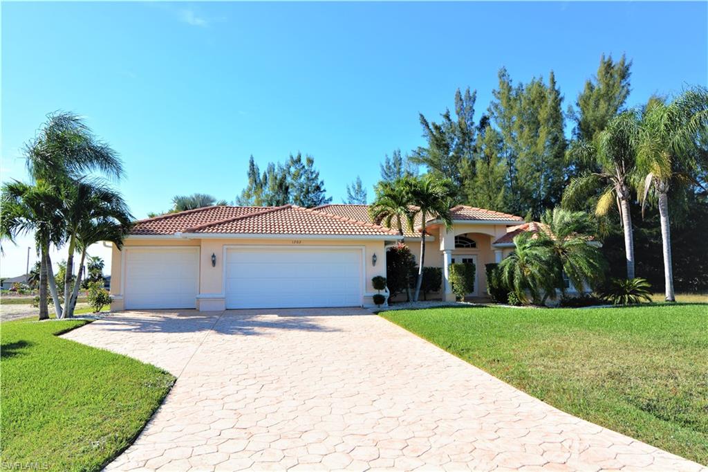 This beautiful pool home on the Carnaval freshwater canal provides a rear west exposure to enjoy the afternoon sun and the gorgeous sunsets of Southwest Florida. Built in 2005 it features 3 bedrooms, 2 bathrooms (one serving as a pool bath), a large den/office/library, a 3-car garage, tile roof, stamped driveway and pool deck, huge pool area across whole width of the house with oversize pool, electric pool heater, granite counter tops, upgraded cabinetry, tiled throughout all areas with exception of bedrooms which have laminate. With the high vaulted ceilings it gives a lot of volume. One guest and the master bedroom have french doors to the pool area, the master bedroom and the den have french doors to the living room as well. The master bathroom has split double vanities and a separate tub and shower. Enjoy the relaxing view from the spacious lanai down the canal. This home invites for outside entertainment with the spacious areas around the pool. The home is located in a wonderful and emerging neighborhood with no thru traffic yet close to schools, playgrounds, shopping and restaurants. Less than a minute out to Chiquita Blvd and then to Pine Island Rd.