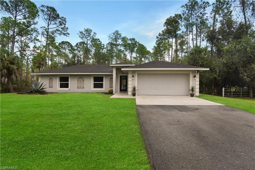 Renovated home on over 2 acres! Situated in a non-gated neighborhood on 2.34 acres of land, this single family home has been updated with gorgeous tile flooring throughout, new a/c unit, custom trim including crown molding, country 10 lite doors throughout, and new washer & dryer. Beautiful kitchen w/ designer cabinets, stainless steel appliances, tile backsplash, bay window system w/ eat-in area, and breakfast bar. Fantastic home for a growing family w/ a split bedroom floor plan, oversized 2-car garage, cathedral ceiling, great room layout, open rear lanai, and a fenced in backyard that has plenty of room for a pool and/ or playset. Both bathrooms in the home have been renovated w/ the master having a frameless glass enclosed shower, and all bedrooms have walk-in closets. Very convenient location-close to all the needs of life while being surrounded by old Florida natural landscaping. Just miles from the Neighborhood Shoppes at Orange Tree offering Publix & much more!