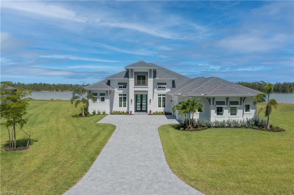 H9936 - HUUUGGE .90 Acre private lot w/ 237 Feet of Lake Frontage!! Largest Home site in Wild Blue! STUNNING NEW Luxury Estate Home w/ Designer Finishes by Stock Devpmt. Stroll the long driveway and your HUUUGGE 12-foot Iron/Glass Entry Door welcomes you home. HUUUGGE OUTDOOR LIVING w/ over 2,000 SQFT Travertine hardscape, custom Pool/Heated Spa, natural gas Fire Pit with an expansive private natural sanctuary to enjoy the Tranquility of the “Big” Lake!. HUUUGGE picture-framed screen enclosure awaits to entertain your next family gathering. Outdoor kitchen is ready for your customization, a perfect spot for entertaining and enjoying the natural surroundings. Only 46 Estate Homes on this private gated peninsula. Tastefully designed estate home has an open-concept Great Rm, One-STORY plan with HUUUGGE MASTER Suite, 3 add'l guest suites with ensuite baths, Bonus/Flex Rm and bath with pool Access, a PRIVATE Home Office. Amenity-rich Lifestyle includes boating, water sports, two community pools, restaurant, poolside grill. bocce, pickle ball, basketball, tennis, biking, hiking. Wild Blue is convenient to I-75, RSW Airport, shopping, dining, Ent. and white sandy beaches.