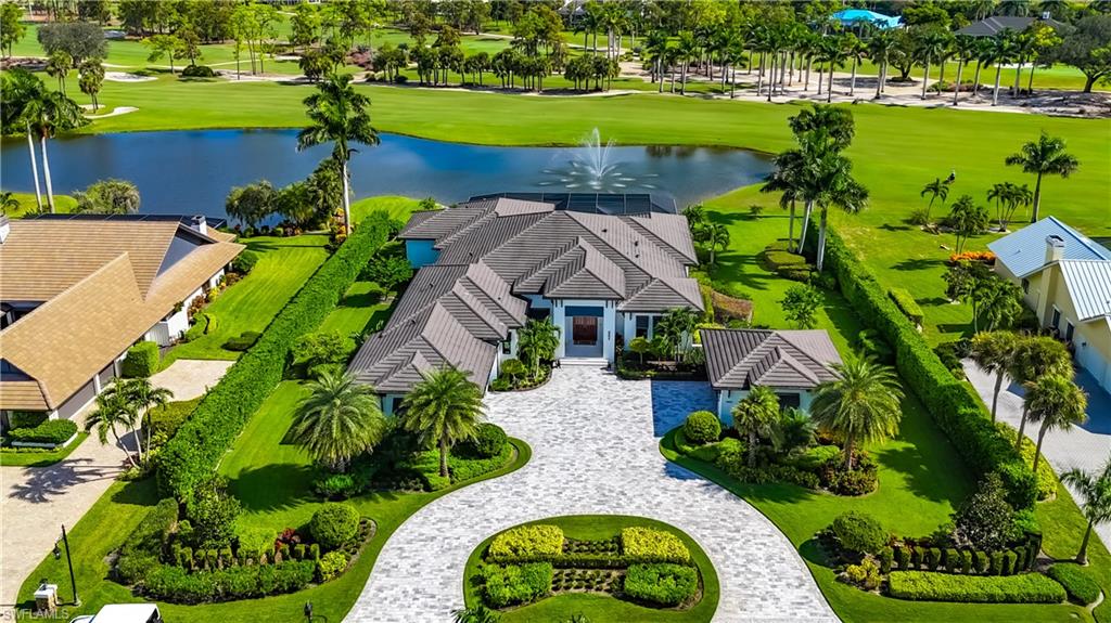 Located in Quail Creek, this exceptional home built in 2019, is located on a premier lot. Featuring stunning architecture and impeccable high-end finishes throughout, 4 bedrooms + den, 4.5 baths, a gourmet kitchen, a spacious outdoor oasis, and four garage spaces. The well thought out floor plan has 5,253 square feet of immaculate living space. Floor to ceiling sliding doors pocket for optimal views of the tranquil lake, lighted fountain, and golf course. This residence is perfect for hosting family and friends as each living space flows seamlessly to the outdoor oasis with a saltwater infinity pool, spa, and water features.  The primary bedroom en-suite includes California closets, walk-in shower, dual sinks, and soaking bathtub. Each of the guest bedrooms are en-suite and have ample closet space. Quail Creek is a gated community and one of Naples’ finest golf course communities offering 36 holes of championship golf with all the privileges of the private club lifestyle. Quail Creek amenities include a fitness center, full service spa, restaurant, tennis & pickleball. Just a short drive to Mercato for some of Naples’ finest world class shopping, dining, & entertainment.