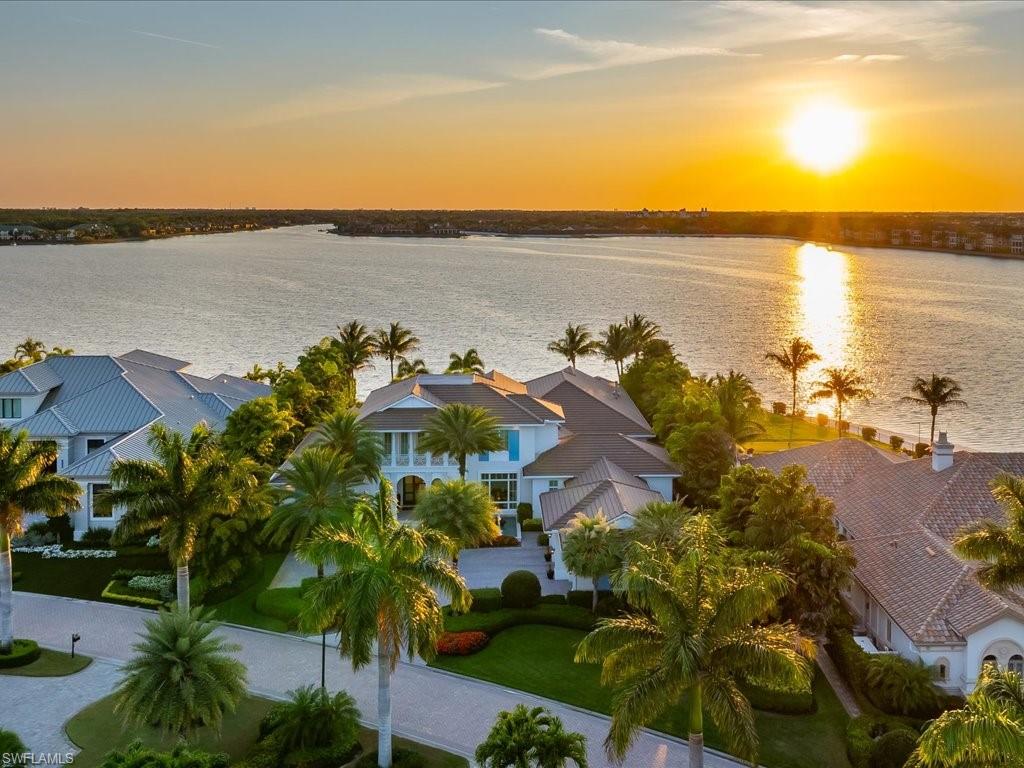 Positioned on an irreplaceable stretch of beachfront within the acclaimed Miromar Lakes Beach & Golf Club, this one-of-a-kind residence is truly the crown jewel of Miromar Lakes. Encompassing 8,316 square feet with 5 bedrooms, 4 full baths, and 3 half baths, it is designed to elevate everyday living into an experience, the home effortlessly caters to those who love to gather, indulge, and unwind in style. From the moment you enter, the home reveals a breezy yet sophisticated coastal aesthetic inspired by classic island architecture. Expansive living spaces flow naturally from one to the next, anchored by a striking great room and a thoughtfully designed culinary space that goes far beyond the expected—perfectly complemented by a hidden butler’s pantry, a quiet workspace, and an additional upstairs retreat for relaxation or guests. At the heart of the home’s entertainment appeal is a statement-making wine cellar with capacity for 800 bottles—an elegant prelude to the showstopping game and media lounge. Spanning over 1,100 square feet, this immersive space was designed for unforgettable nights, featuring a full-service bar, multiple viewing areas, gaming tables, and a private theater setting that rivals any luxury venue. Outdoor living is equally extraordinary. Disappearing glass walls open to a sprawling lanai where a resort-style pool and spa take center stage. The setting is enhanced by a fully equipped outdoor kitchen, a premium Evo grill, and a handcrafted Italian pizza oven—creating a space where hosting feels effortless and every gathering becomes an occasion. The primary suite is a secluded haven, offering a calming, spa-like environment complete with a luxurious bath, dual closets, and a unique outdoor shower framed by a marble waterfall. Additional guest suites are generously sized and beautifully appointed, ensuring every visitor enjoys their own private escape. All of this is just steps from the pristine white sands and shimmering waters that define Miromar Lakes, along with access to world-class amenities including waterfront dining, boating, tennis, pickleball, and championship golf. This is more than a home—it’s a signature property in one of Florida’s most celebrated communities.