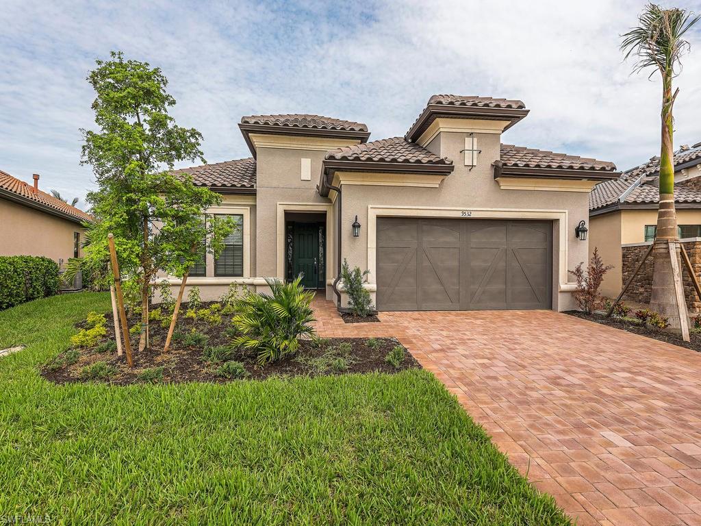 This home has never been occupied and is brand new!  Large water view and plenty of outdoor space, both covered and uncovered give this home great entertaining possibilities.  The home is situated on a large cul-de-sac lot with abundant side yards.  Featuring every upgrade available including huge garage, hard tile floors on ALL surfaces, tray ceilings, crown molding, cabinets, built in appliances, outdoor kitchen with bar, impact windows and doors, and a walk in shower for all.  Very low fees with the CDD debt service paid off!!  Fiddler's Creek offers world class amenities including Social Club, Day Spa, state of the art Fitness Wing, Tennis, and options for Golf, Beach, and Marina.
