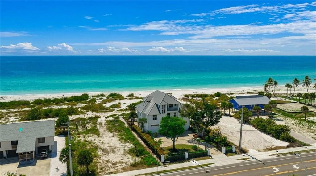 Four-bedroom, four-and-a-half-bathroom Potter beachfront estate on the highly coveted south end of Fort Myers Beach—introducing one of the last true legacy opportunities along prestigious Estero Boulevard. Expertly built by Potter Homes, this coastal masterpiece blends timeless architecture with modern updates and irreplaceable direct private beach access.

From the moment you arrive, the gated entry and expansive front lawn create a grand first impression—an uncommon feature on the beachfront. Lush, one-of-a-kind tropical landscaping frames the residence, delivering exceptional curb appeal and privacy rarely found along Estero Boulevard.

Inside, the spacious and thoughtfully designed layout offers both elegant entertaining spaces and relaxed coastal living. Expansive windows invite natural light and Gulf breezes, while multiple en-suite bedrooms ensure comfort and privacy for family and guests alike.

Recent enhancements include a new metal roof and a beautifully resurfaced lower-level pool deck, where a private jacuzzi and generous outdoor living areas create a resort-style retreat just steps from the sand. Whether hosting sunset gatherings or enjoying quiet mornings by the water, the setting is nothing short of extraordinary.

Zoned for weekly rentals, the property also offers strong income potential—making it equally compelling as a primary residence, luxury second home, or investment opportunity. The generous floor plan and premier location position it perfectly for those seeking both lifestyle and flexibility.

Ideally situated within walking distance to Santini Plaza’s reimagined dining and boutique shopping, and just a short drive to Bonita Springs, Naples, and Southwest Florida International Airport, this south-end location offers convenience without sacrificing serenity.

This is more than a home—it is one of the final opportunities to secure a true beachfront legacy property on Estero Boulevard.