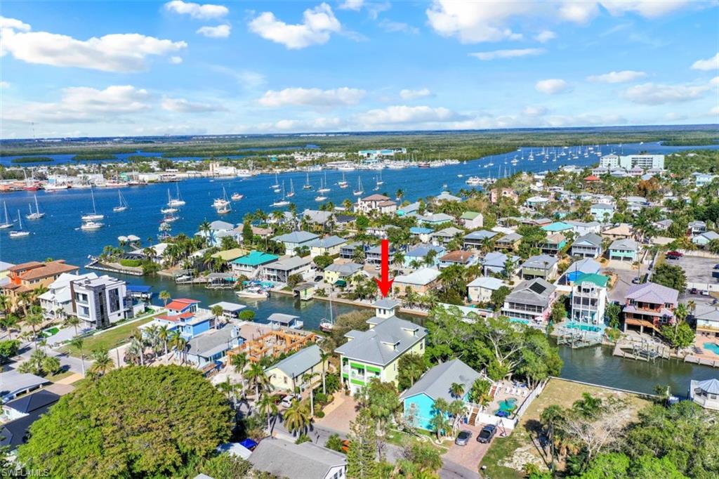 Paradise awaits! This custom waterfront resort style home affectionally known as “Fresh Squeezed” is filled w/upgrades and is being offered turnkey. Upon entering the residence, you are welcomed in the Grand Foyer.
This level has a full-size game room, entrance to pool/spa/shower/sundeck and dock area, bedroom, and half bath. The grand staircase or private elevator welcomes you to the upper floors. On main level, enjoy soaring ceilings, great room, chef inspired gourmet kitchen w/island seating, water view dining area, stacking "wall of windows" to lanai overlooking pool/spa/dock/outdoor kitchen & beautiful bay/canal views. The 1st master bedroom suite is well appointed, w/large lanai, and den w/private balcony. The next level offers a 2nd master bedroom suite, private screened lanai, 2 large bedrooms and full bath, all of which grace this level. The top level, via a circular staircase has a rooftop “crow's nest" sitting area for panoramic views of the Gulf, back bay, and the beauty of Estero Island. The white sand of Fort Myers Beach is a short sail from your private dock or a 7-minute walk from "Fresh Squeezed" to beach area activities, restaurants, and shopping at Times Square.