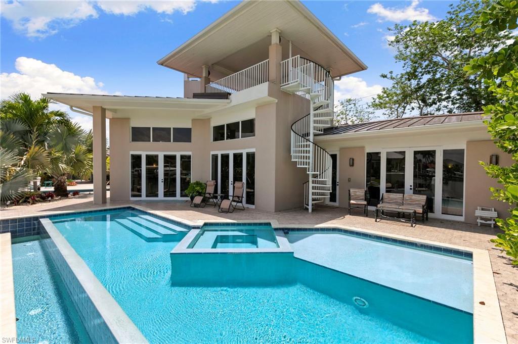 Experience exceptional waterfront living in this one of a kind island retreat featuring 3 bedrooms, 3 full baths, 2 half baths, long water views, and the rare luxury of 2 pools. Thoughtfully designed around a stunning courtyard concept, this remarkable residence blends elegance, privacy, and resort style living with soaring ceilings, an open floor plan, fireplace, abundant natural light, and beautiful architectural details throughout.

The chef’s kitchen is beautifully appointed with custom cabinetry, stainless steel appliances, granite countertops, gas cooktop, large pantry, and an impressive wood bar ideal for entertaining. The spacious primary suite offers tranquil water views, lanai access, a large walk in closet, and a luxurious ensuite bath highlighted by dual vanities and a custom stained-glass mermaid feature in the walk in shower. Each guest bedroom includes its own private ensuite bath, creating a comfortable retreat for family and visitors alike.

Outdoor living is truly unmatched with 2 pools, spa, fountain, cabana style German bar, pool bath, lush tropical landscaping, and a second story observation deck capturing breathtaking waterfront views. Boaters will love the private dock with lift and quick direct Gulf access just minutes to the Marco River and the Ten Thousand Islands. Additional features include impact windows and doors plus a whole house generator for added peace of mind. This extraordinary waterfront residence delivers the ultimate Marco Island lifestyle.