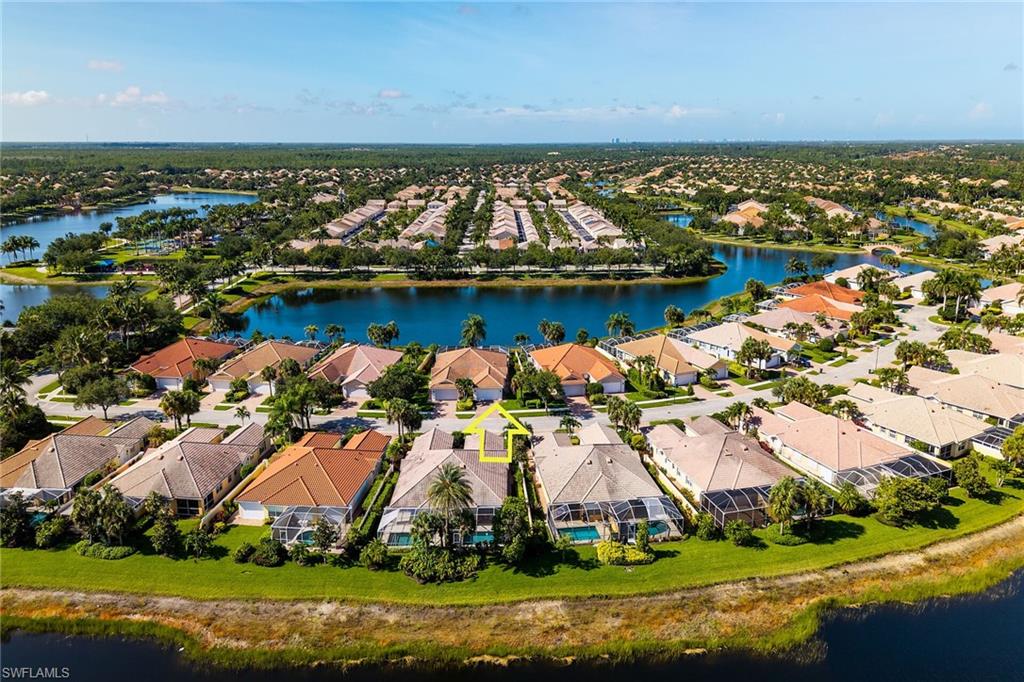 Rare opportunity to own a lakeside villa in the sought-after gated community of VeronaWalk. Serene lake views from the open floor plan and master bedroom, plus vaulted ceilings and an abundance of natural light create an open and inviting atmosphere throughout. This home is not in a flood zone, built by Divosta with solid poured concrete construction, and has attached hurricane shutters for your comfort and safety. This spacious single-story Capri villa features 2 bedrooms, 2 baths, a den, and a two-car garage with built-in workbench.  The split-bedroom floor plan with each bedroom enjoying its own private bath and walk-in closet has additional storage closets and cabinets throughout. Important updates have already been completed, including a newer roof, air conditioning system, and water heater. The centrally located kitchen features stainless steel appliances, generous counter space, and overlooks the living and dining areas, making entertaining family and friends effortless. Step outside to your covered lanai and screened pool area, where wide lake views provide a beautiful backdrop for morning coffee, evening cocktails, and peaceful sunsets. Abundant birdlife and tranquil water views make this outdoor living space truly special. VeronaWalk residents enjoy an impressive array of amenities,a resort-style pool, lap pool, fitness center, tennis courts, pickleball, bocce, basketball, miles of walking and biking paths, and a vibrant calendar of social activities. The centrally located Clubhouse complex includes restaurants, a beauty salon, library, and a gas station. Scenic bridges, sparkling lakes, beautifully landscaped streets, and 24-hour guarded gate access make VeronaWalk one of Naples' most desirable communities. Whether you're searching for a full-time residence, high end rental property, or a seasonal getaway near the heart of Naples close to shopping, beaches, and more, 7784 Ionio Court delivers the best of Southwest Florida living.
