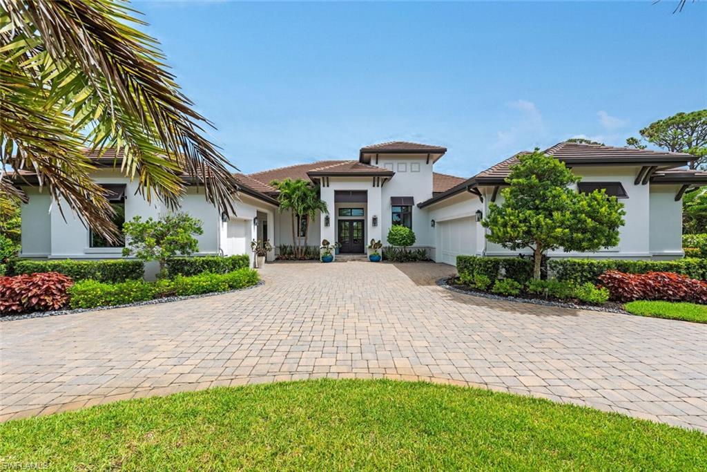 179 Mahogany Dr., a magnificent residence located in the prestigious Pine Ridge Estates. Situated on a 1.51-acre fenced lot. No expense has been spared in creating a luxurious atmosphere, with top-of-the-line features and finishes throughout. The gourmet kitchen is a culinary enthusiast's dream, equipped with Jenn Air appliances, an expanded island, and plenty of cabinet space. The interior design of this home is wonderful, with custom ceilings, crown molding, and attention to detail evident in every room. The master bedroom is a sanctuary of tranquility, featuring spacious walk-in closets and a large master bathroom. For those who appreciate a work-from-home environment, the study is equipped with built-in wall cabinetry and an adjacent wet bar, creating a functional and stylish workspace. The outdoor amenities of this home are equally impressive, allowing for a seamless transition from indoor to outdoor living. The covered lanai provides a shaded retreat, while the outdoor kitchen with grill and bar invites you to entertain in style. The heated salt pool and spa provide a refreshing escape, while the gas-raised fire feature adds a touch of ambiance.