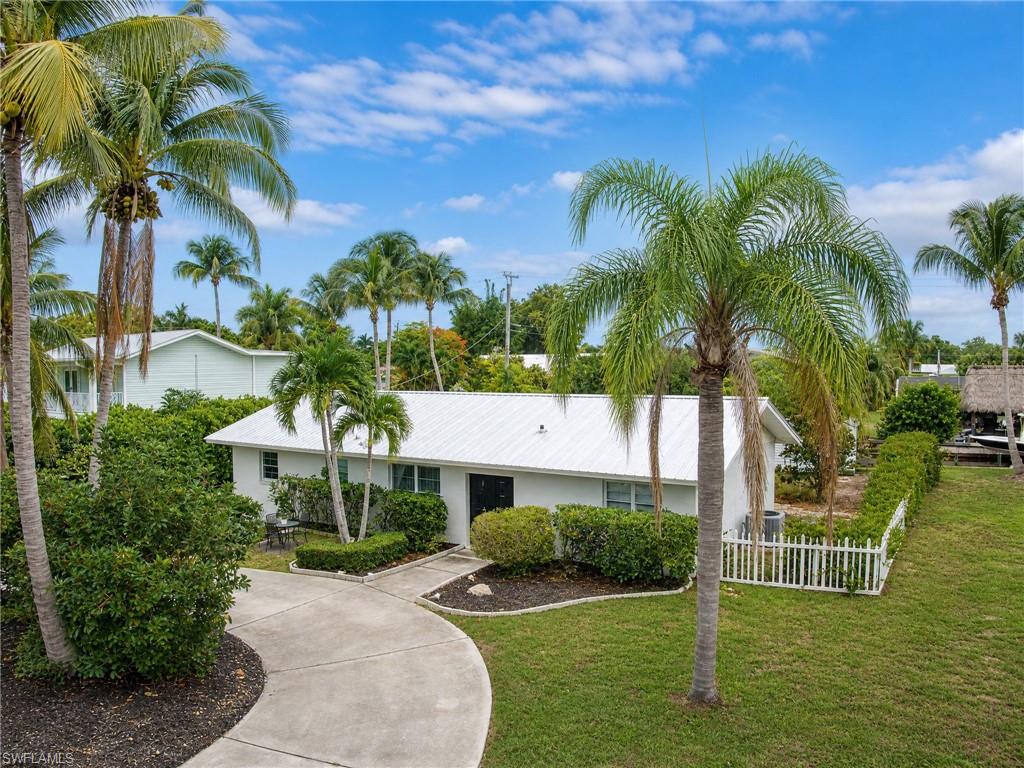 Experience Gulf-Access living from the highly sought-after Whiskey Creek Canal! This beautifully remodeled (2023) waterfront pool home offers 2 bedrooms, 2 bathrooms, and a short 15-20 minute boat ride to the Caloosahatchee River. Updates include a Metal Roof (2022), a new pool liner (2023), and modern interior renovations throughout. Both bedrooms feature ensuite bathrooms, while the spacious primary suite offers an oversized walk-in closet with additional storage. NO RENTAL RESTRICTIONS! This property is an income-producing Short-Term Rental/Airbnb, making it an excellent opportunity for investors, seasonal residents, or full-time homeowners alike. The backyard is perfect for enjoying the Southwest Florida lifestyle, featuring a private pool, outdoor kitchen, fishing from your dock, and direct boating access to the Gulf. Two additional outbuildings provide space for a workshop, hobby room, storage, or space for recreational equipment. A circular driveway and expanded paved parking area offer ample room for multiple vehicles, guests, trailers, or boat storage... an uncommon and valuable feature for waterfront properties. Conveniently located off of historic McGregor Blvd, enjoy nearby shopping, dining, entertainment, and downtown Fort Myers. Schedule a showing and make an offer today!