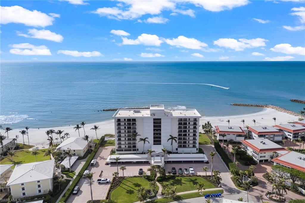 Enjoy direct, unobstructed front-row views of the Gulf from this exquisitely updated beachfront residence showcasing refined coastal luxury and light-filled living. Widely regarded as offering one of the captivating views in all of Naples, this three-bedroom, three-bath end unit features a spacious open floor plan designed to maximize water views and natural light. The expansive great room opens to a screened, covered Gulf-front balcony and is enhanced by wide-plank wood-look flooring. The beautifully updated kitchen offers custom white cabinetry, quartz countertops and GE Profile appliances, seamlessly connecting to an elegant dining area with a built-in bar and wine cooler, ideal for entertaining. A second, bay-side balcony allows for refreshing front-to-back breezes. The generous primary suite enjoys gulf views and balcony access, while two additional guest suites each feature their own en-suite bath. Gulf View Beach Club has one of the desirable beachfront locations south of Doctor’s Pass, and is an intimate building with just 32 residences, offering direct beach access, a beachfront pool and patio, social room, fitness center, on-site manager, individual storage rooms, paddleboard and kayak racks. Just minutes from luxury shopping and fine dining of downtown Naples, this is beachfront living at its finest.