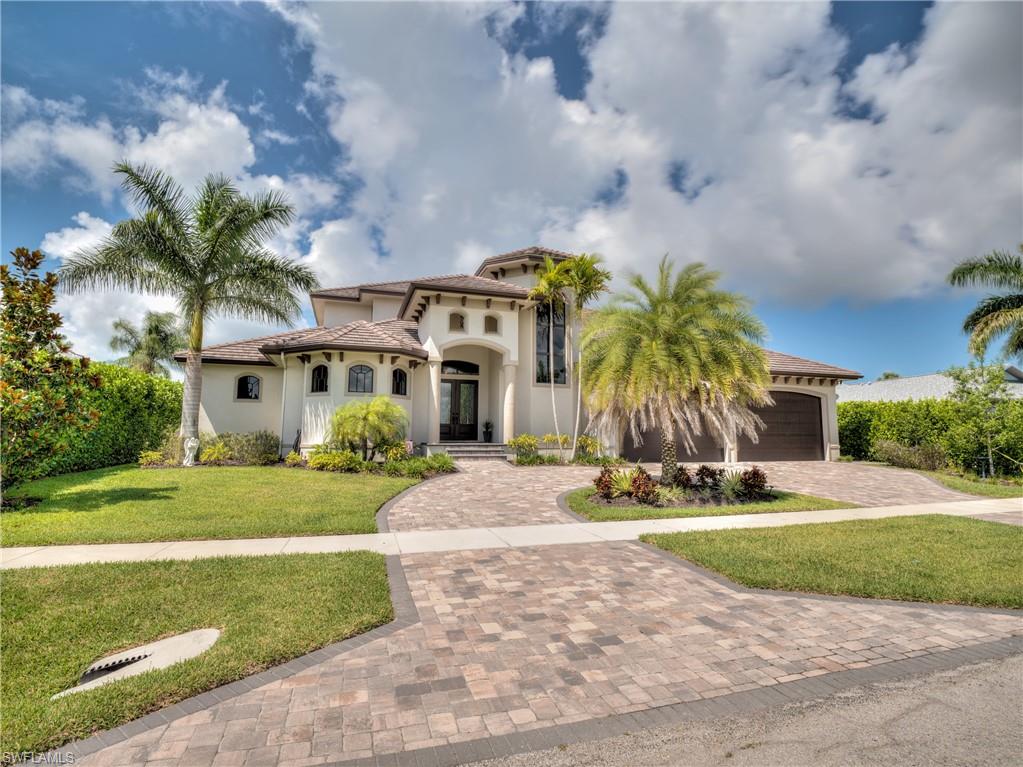 This direct Gulf access, 2- story home was built to last. No damage in Hurricane Ian! This custom-built home boasts 5 bedroom, 5 baths, 2 half baths, office, pool, outdoor kitchen, boat lift and so much more. An open, great room flows into the gourmet kitchen which impresses with a nearly 12-foot island, KitchenAid appliances, quartz countertops, wine cooler, ice maker and other gorgeous finishes. The large, covered lanai with outdoor kitchen, private pool with sun shelf, and spa are perfect for entertainment and relaxation. The main floor master suite opens to lanai, large walk-in closet, double vanities, large walk around shower and stand-alone tub. Two additional bedrooms with en-suites are on the 1st floor. The second floor features an entertainment area with a full wet bar, 2 bedrooms with en-suites, and an expansive, covered balcony. Your private boat dock awaits with a 16,000 lb lift as well as a double jet ski lift. The 4-bay garage has 10-foot garage doors, a 7,000lb car lift, and additional storage. Other features include hurricane doors and windows, automatic hurricane roll down shutters for lanai, camera security system and more.