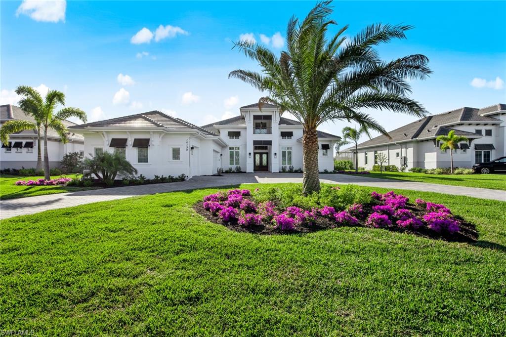 Absolutely Stunning NEW custom-designed home by Stock Development that includes many owner's selections of upgrades such as an oversized lanai with a picture frame lanai cage. The outdoor kitchen is a perfect spot for entertaining and enjoying the natural surroundings. The outdoor living area also has a beautiful natural gas fireplace to relax around. The home is situated on a premium lakefront lot that offers a spectacular view.   There are only 46 custom estate homes on this private peninsula. This tastefully decorated home has a great room floor plan, two primary suites, and two additional guest suites. The Private den/study is located off the main living area, as is the powder room. The Chef Inspired kitchen is enhanced with top of the line appliances and tasteful countertops that accent the beautiful cabinets. The occupancy Certificate was issued in late 2022. Enjoy this amenity-rich community that has boating, a community pool, bocce ball, pickle ball, tennis, biking, hiking, and, coming soon, a restaurant and pool grill. Wildblue is convenient to I-75, RSW Airport, shopping, dining, and white sandy SWFL beaches. OVER $500,000 IN UPGRADES INVESTED BY SELLER IN THIS HOME!