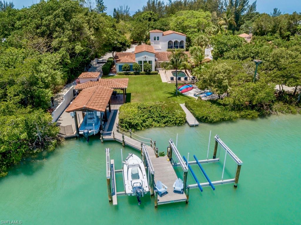 Awesome Spanish Colonial Revival waterfront estate w/roughly 2 acres of natural island landscape directly across the street from golf cart accessible deeded beach access. A fisherman's paradise w/a very unique/rare dock/entertainment set up featuring 3 boat lifts with 60,000 lb total capacity. Two covered boathouses & outdoor sitting areas. The main residence offers 4 lg. suite areas w/ gorgeous master retreat. Awesome gaming & kids fun room. wine cellar, Lg main great room & dining area w/lg chefs kitchen. Amazing design elements throughout that display the authentic architectural character that include cypress beams, Saltillo tile floors, hand fired decorative tiles & more. Outdoors, enjoy a lush landscaped waterfront setting. Open pool area, lots of porches, poolside cabana w/fireplace & more.The estate offers a full service two bedroom guesthouse w/a modern fun twist inside. Make memories w/this fantastic waterfront Captiva Island Estate that everyone will love and enjoy! This property also includes 16615 Captiva Drive.
