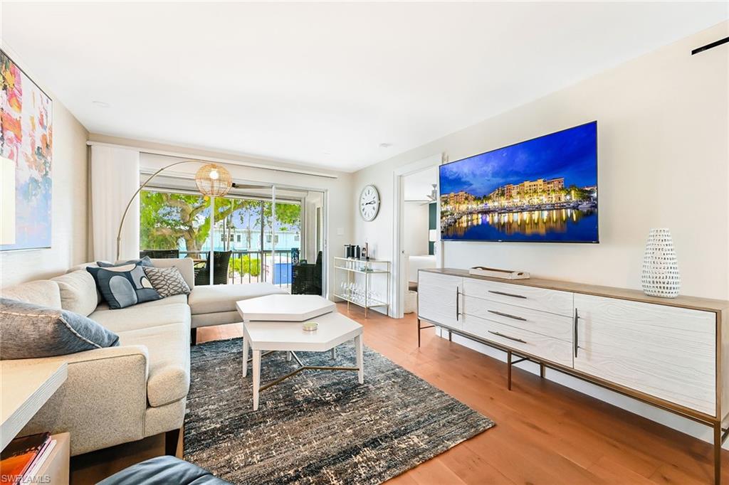 AVAILABLE WINTER 2027.  Just steps from the BEACH and exquisite shopping and dining on FIFTH AVE and THIRD STREET.  This exquisitely REMODELED condo is just 2 blocks from the white sand beach of the Gulf of Mexico; 2 blocks from glamorous 5th Avenue South with its world-famous shops and restaurants, and 4 blocks from the charm that adorns the 3rd Street Shopping District. Ideally located, chic and comfortable, this 2-bedroom, 2 bath 1,000 square-foot 2nd floor end-unit with elevator access offers a state-of-the-art kitchen with counter seating, a comfortable living space with a large, mounted TV, and a true screened lanai facing south over the building's enlarged patio area with outdoor seating.  The primary bedroom offers a king-sized bed, and the primary bathroom has beautiful built-in shelving, a walk-in shower and a generous walk-in closet. The second bedroom is furnished like a den with a desk and a sleeper sofa that can serve as both a queen OR a twin bed - depending on the need.  The second bathroom also offers a walk-in shower.  The unit comes with one assigned parking space as well as guest parking, but who needs a car?