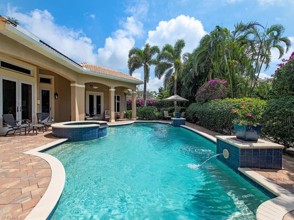 H9316.  True value in this classic residence custom built in 2007 on 0.39 acres benefiting from multiple updates since 2015. Entry foyer leading to formal living room with views of a south-facing covered veranda, pool and spa surround and garden, lushly landscaped and fenced. Formal dining room; generously proportioned private study; great room with vaulted ceilings - a light-filled gathering space with gas-fed fireplace that adjoins a family dining area and well-designed kitchen. Veranda: multiple seating areas, dining space, outdoor kitchen and the pool accessed via corner-opening sliding doors. Primary suite: generous in size, separate reading area, two large and fitted closets, double sinks, jetted tub, separate shower and bidet. Second level: two ensuite bedrooms with covered balcony accessible from each room. Note: whole-house water filtration system; 500-gallon in-ground gas tank (fuels outdoor grill, great room fireplace, and 22KW whole-house generator); solar and electric pool heater; impact windows and doors; partially shuttered lanai; 3-bay garage with storage cabinets; ACs (2020); water heater (2021). MPOA membership available to Moorings residents.