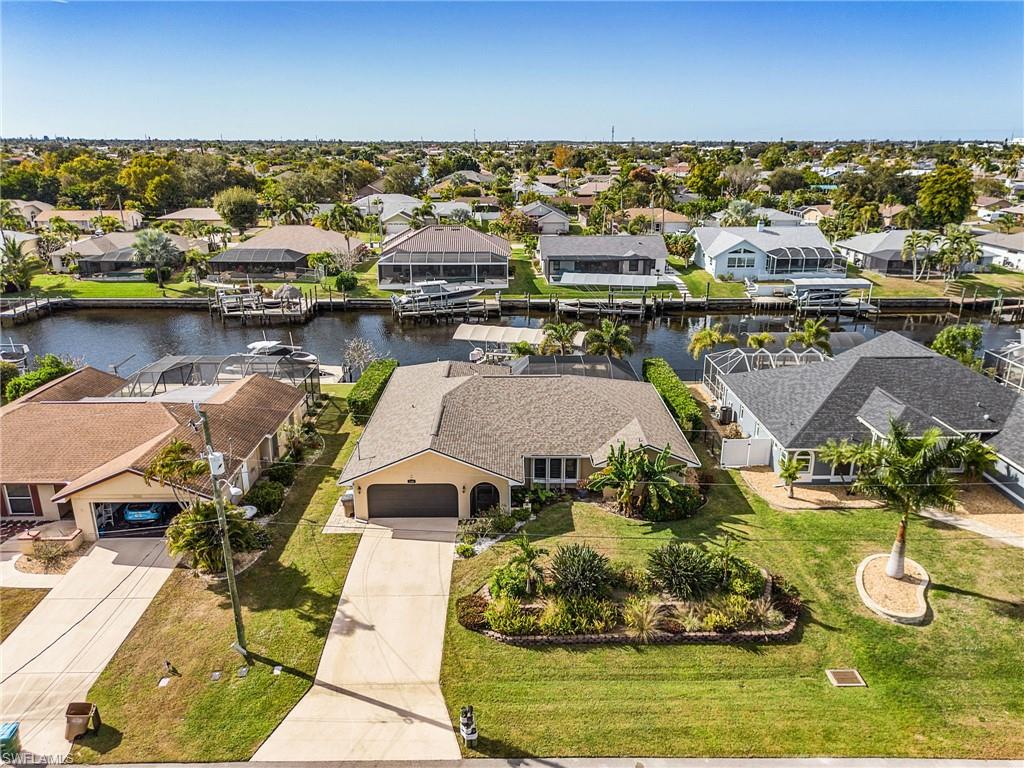 DIRECT GULF ACCESS • ONE TURN TO RIVER • 120’ WATERFRONT • 16,000 LB BOAT LIFT

Life starts here on the water—and ends with sunsets over the canal.

Perfectly positioned on a direct Gulf access canal with no bridges and just one turn to the Caloosahatchee River, this Cape Coral waterfront home delivers the boating lifestyle buyers are actively searching for but rarely find. With 120 feet of waterfront and wide canal views, this property offers quick, effortless access to open water, waterfront dining, fishing, barrier islands, and the Gulf of Mexico.

A true boater’s setup, the home features a private dock with shore power and water, along with a 16,000-pound boat lift with a 14-foot beam, accommodating larger vessels with ease. The dock and lift were replaced in 2020, providing long-term confidence and usability.

Inside, soaring ceilings and elegant 22-inch porcelain tile flooring create a bright, open, and cohesive living space throughout the entire home. The layout includes three sets of large sliding glass doors that fully connect indoor living areas to the lanai and pool, flooding the home with natural light and maximizing the waterfront views from multiple vantage points.

The kitchen is finished with granite countertops, updated black stainless-steel appliances, ample cabinetry, and a large walk-in pantry. Granite continues into the bathrooms, creating a consistent, elevated finish throughout the home.

The desirable split-bedroom floor plan offers privacy and functionality. The spacious primary suite features dual walk-in closets, an ensuite bath, and convenient access to the outdoor living area. The guest bathroom also functions as a dedicated pool bath, providing easy access from the lanai and enhancing everyday convenience for entertaining.

Step outside and the lifestyle takes over. A covered lanai and heated saltwater pool overlook the wide canal, creating the perfect setting for morning coffee, afternoon relaxation, and unforgettable Southwest Florida sunsets. Recently refinished in 2025, the outdoor living area is designed for year-round enjoyment.

Peace of mind comes standard with extensive recent upgrades, including:

• New roof and gutters (2023)
• Air conditioning system (2020)
• Hot water heater (2025)
• Pool equipment (2024)
• High-efficiency smart pool heater (2024)
• Pool and lanai refinishing (2025)
• Dock and 16,000 lb boat lift replacement (2020)
• Generlink Generator hookup installed by LCEC (2025)
• Electric roll-down storm shutters
• Easy manual roll-down storm shutters

The exterior is enhanced with tropical landscaping featuring banana and pineapple plants, creating a private Florida-style setting. 

All city assessments are in and fully paid.

Conveniently located near Rosen Park Boat Ramp, shopping, dining, entertainment, downtown Fort Myers, beaches, and major roadways, this home offers immediate access to everything Southwest Florida has to offer.

Click video walk thu tour.
