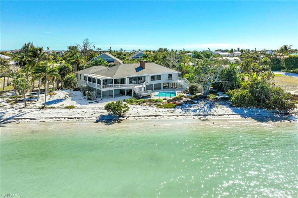 Location, Location, Location! This 1st time on the market bay residence is one-of-a-kind. Unique bay-front setting features panoramic views of the Bay & Gulf of Mexico. Envision watching the dolphins play, manatees meander & pelicans hover, from your pool deck. Allow waves & gentle breezes to rock you to sleep. This desirable East-end retreat is arguably one of Florida's most coveted coastal, serene settings. Located on 200' on the bay by 184' of privacy, nestled at the end of Ferry Rd cul-de-sac, down a private sand road with only four homes, this over-sized bay-front lot encompasses an elevated 5 bedroom, 4 bath, pool home with expansive multi-level decks, including spa deck off master bedroom, an open air pool with large recreational space. A bay-side garage door allows for launching your personal jet skis, small water craft or kayaks at your secluded beach, noted for world-class boating and shoreline fishing. Just a short stroll down the beach lands you at the historical Sanibel Pier & Lighthouse or cross Periwinkle Way for your deeded easement beach access to the Gulf. The open floor plan with separate guest wing designed by island resident Ray Fenton offers ideal living areas creating a balance of privacy & shared space. Interior features includes staircase next to elevator shaft (elevator ready design) to service main living level. French doors draw your attention to the wood burning fireplace enclave. This extraordinary water front setting can be renovated or developed to your personal taste.