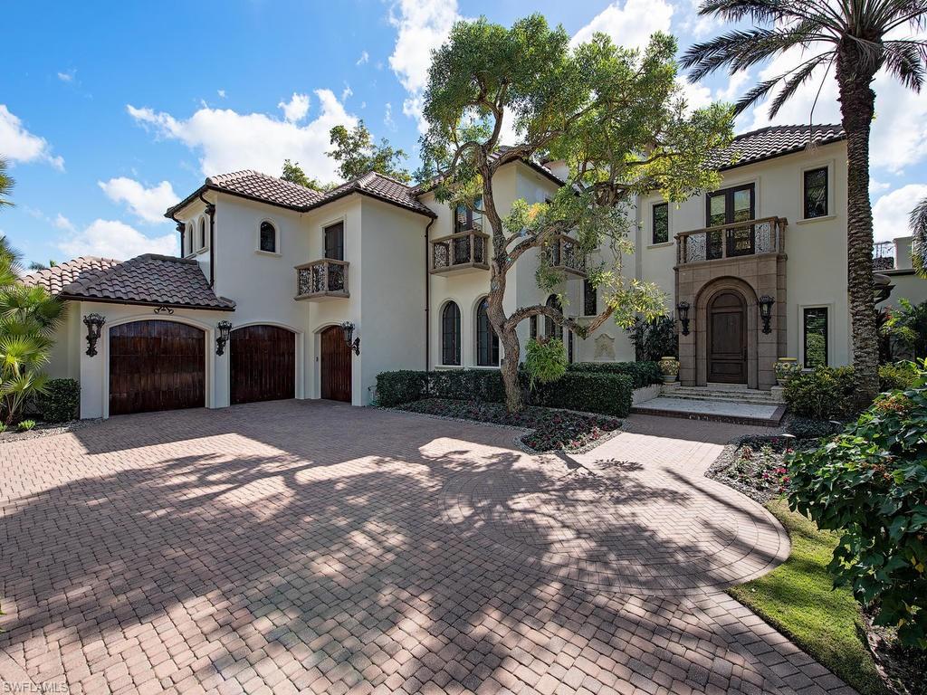 Beautiful park like setting surrounds this Port Royal property.  This southern exposure home has 148 feet of water frontage and one of the longest water views.  For entertaining there is an outdoor kitchen, large lanai with fireplace, expansive patios and courtyard. 3 car air conditioned garage.  New a/c units, water heaters, and recently painted exterior. Immediate Port Royal Club membership eligibility .