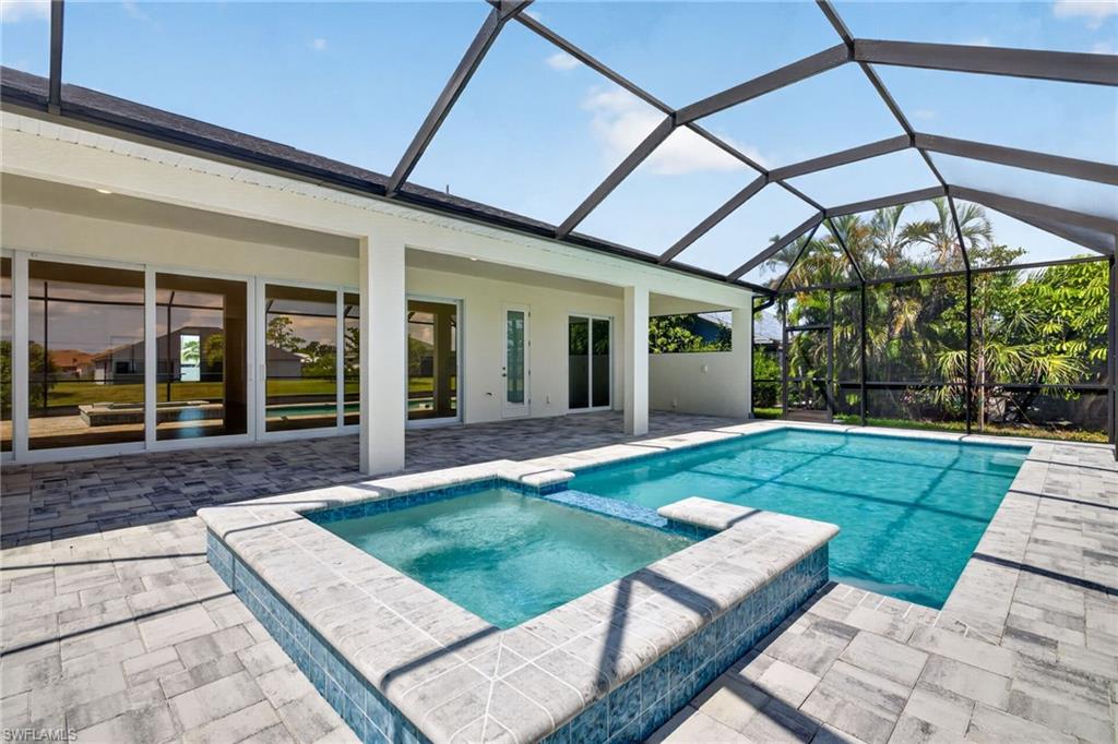Coral Haven — multiple-award winner at this year’s Showcase of Homes — Not in a flood zone! Hurricane Impact windows and sliders! Offers wide canal view, a heated pool and spa, and a 1,100 sq. ft. screened lanai that extend effortless indoor/outdoor living. The open plan centers on a chef’s kitchen with a large island, quartz counters, upgraded shaker cabinetry, dovetail drawers, and a huge walk-in pantry; a 24' sliding glass span floods the living space with light and frames the waterfront vista. Two luxurious primary suites (tray ceilings, walk-in closets, private baths) a 3-car garage, and a premium homesite outside the flood zone round out the package—luxury, function, and low insurance costs. Schedule a showing to experience this model-perfect waterfront home in person. One or more photo(s) was virtually staged. This is The Coral Haven Plan.