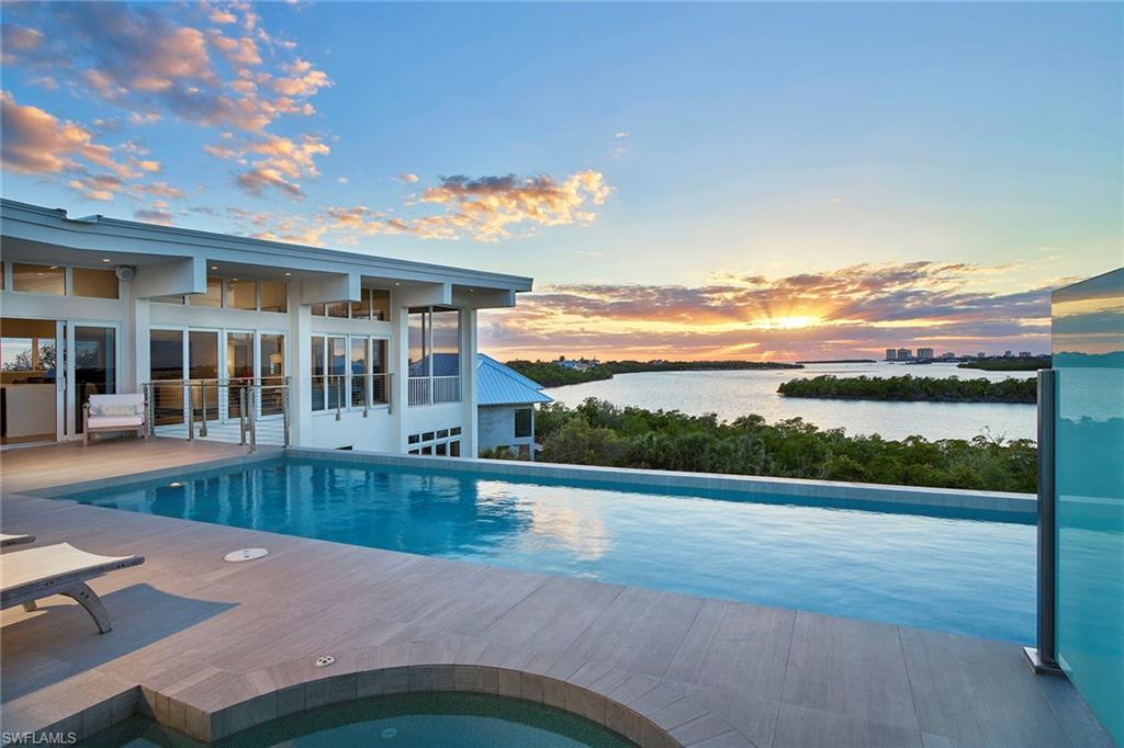 Few have possessed the passion to create a home, resort-style oasis that elevates nature into a starring role. This incredibly rare setting offers stunning views of Marco Island, Barfield Bay, and the Gulf of Mexico that never fail to amaze. This three-level contemporary estate with 25 feet of elevation offers a design that flows with ease and simple beauty. The inverted plan has all the home’s most important living spaces on the upper level with 180-degree unobstructed views including the living area, pool/spa deck, screened-in lanai, a beautiful kitchen with generous quartz counters and professional-grade appliances. The middle level is the owner’s retreat with the master bedroom and en-suite bath, two offices and additional bath. The lower level is a secluded, self-sufficient living area with two bedrooms. Each comes with a private bath, full kitchen with a breakfast bar and screened-in lanai. Additional amenities include impact-resistant windows, elevator, generator, LED & Lutron-controlled lighting, advanced security and more to ensure ultimate privacy and peace of mind. Located in the historical gated community of Key Marco, which includes direct access to a private marina.
