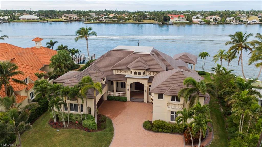 H.12594 Situated on .41 acres on Naples Bay, this exquisite home defines "living large" with a four-car garage, guest quarters and a luxurious master suite.  Travel throughout the main living spaces where will find ample space to entertain guests with both formal and informal dining options, as well as, a beautiful kitchen, complete with all the modern-day conveniences to make entertaining a breeze.  This spectacular home features 134 feet of water frontage on Naples Bay, a dockside deck with 2 jet ski lifts, as well as, a private boat house with lift equipped to house a 40 foot vessel.  This must see home is being sold "AS-IS" at a price far below Carroll & Carroll's appraisal of well over $4 million dollars!  SHOWINGS FOR THIS SPECTACULAR PROPERTY WILL BEGIN ON FEBRUARY 7TH OF 2018!