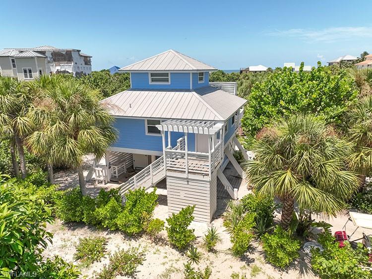 Adorable island cottage on beautiful North Captiva Island with classic beach style. This bungalow offers three sleeping rooms, making great use of the space. The living room and kitchen area are full of charm with tongue-and-groove wood walls, an authentic coastal retreat style. The two levels of decking are great for watching sunsets and gathering with the family.  The home is located on a valuable oversized lot, just a short stroll or golf cart ride to the nearest beach access. Plenty of room to add on or install a large pool and outdoor entertainment area. Impact windows and sliders throughout, plus new hardie-board siding. Don't miss out on the chance to affordably obtain your beach house dream goal on this one-of-a-kind island!