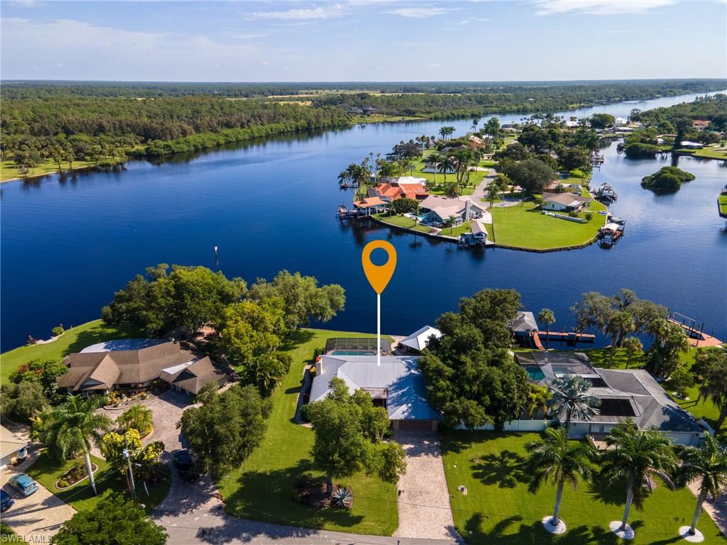 Welcome to the Island! Beautifully updated 3 bed 2 bath pool home with direct Caloosahatchee River/Gulf access. This amazing property boasts a private covered boat slip with lift, screened-in lanai, salt pool with spa and amazing views. Only a short drive by boat or car to down town Fort Myers. Move-in ready with great floor plan and easy maintenance terrazzo flooring throughout the house. Don't miss out on this island gem, it won't last long!  One year home warranty included.