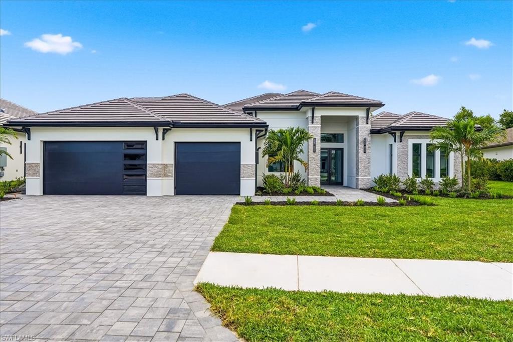 Welcome to a truly exceptional new construction residence in one of Naples’ most desirable neighborhoods, Naples Reserve, featuring 4 bedrooms, an office, and 4.5 bathrooms. Thoughtfully designed with a modern organic aesthetic, this custom home blends warm natural materials with clean architectural lines to create a sophisticated yet inviting living experience. From the moment you arrive, the striking façade showcases a harmonious mix of stone, wood accents, and contemporary finishes, setting the tone for what awaits inside. Step through the grand entry into a light-filled interior featuring soaring ceilings, neutral flooring, and a seamless open-concept layout. At the heart of the home, the designer kitchen is both functional and stunning, complete with custom cabinetry in natural tones, an oversized waterfall island, high-end appliances, and elegant accented fixtures. The kitchen flows effortlessly into the dining area and expansive great room, where a custom-built feature wall and linear fireplace create a warm focal point, perfect for entertaining or relaxing in style. The luxurious primary suite offers a serene retreat with large windows and a spa-inspired bathroom featuring a freestanding soaking tub, dual vanities, and a glass-enclosed walk-in shower. Additional bedrooms are thoughtfully designed with elevated finishes and abundant natural light. A private study with custom built-ins provides the ideal work-from-home space. Every bathroom throughout the home showcases curated materials and designer fixtures for a cohesive, high-end feel. Step outside to your resort-style outdoor living area, complete with a covered lanai, summer kitchen, and a stunning pool surrounded by stone decking. This space is designed for year-round enjoyment, blending indoor and outdoor living effortlessly. Residents of Naples Reserve enjoy an exceptional lifestyle with access to resort-style amenities including a clubhouse, zero-entry pool with lap lanes, fitness center, café, fire pit, lakefront beach with volleyball, tennis and pickleball courts, bocce ball, dog parks, boat ramp, miles of scenic walking paths, and a soon-to-be-updated clubhouse featuring an outdoor bar.