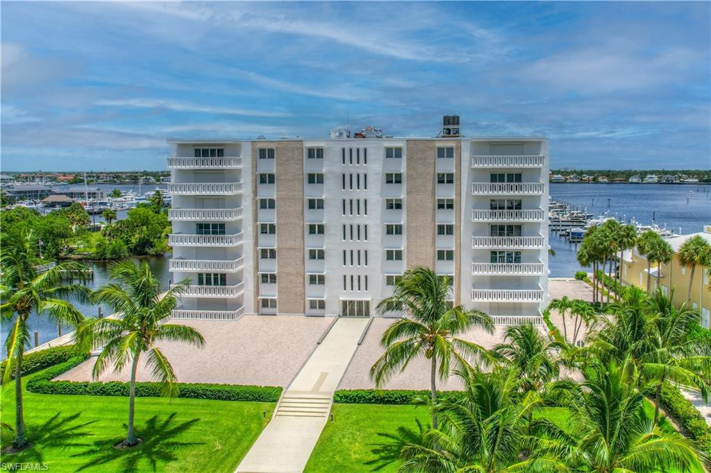 RARE FIFTH FLOOR corner residence in iconic Bay Terrace, the mid-century gem with direct frontage on Naples Bay, and the only high rise in Olde Naples. Bay Terrace is your only opportunity to live above the third floor in Olde Naples. This light and bright home showcases panoramic water and city views from Golden Gate to Marco Island. Enjoy downtown living, convenient boating and ever changing sunrises from this home, with its great location, private docks and eastern exposure. The location, steps to the Naples Yacht club, offers an easy walk to the City Dock, the exceptional restaurants and shops of Third Street South, and Naples stunning beaches. Owners enjoy guest suites for extended family and friends, boat slips for annual lease, secure under building parking, and indoor storage. A 24 hour on-site manager, electric, A/C, heat, water, sewer and basic cable are included in the quarterly condo fee.