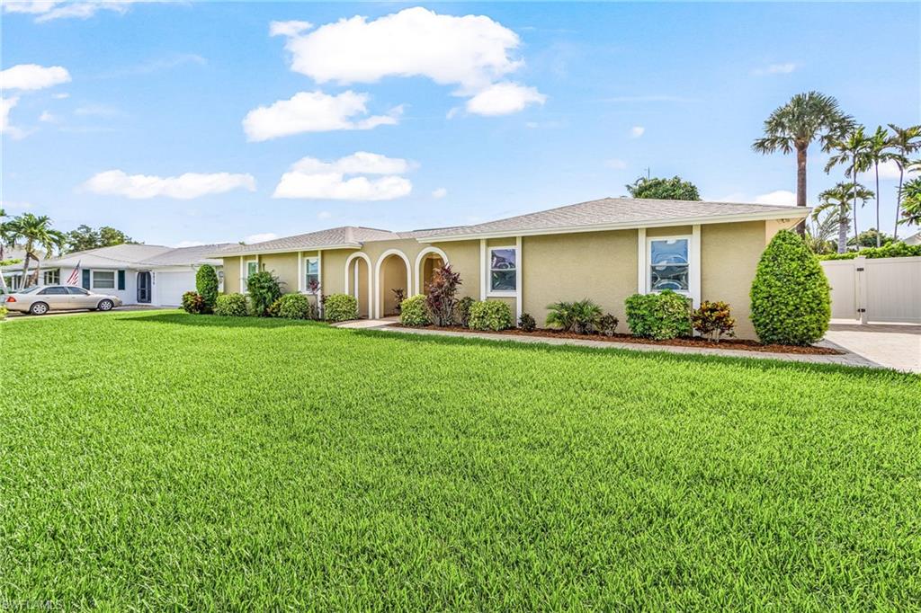 This Gulf-Access 3 bedroom and 2 Bath pool home In McGregor Isles has two covered boat lifts and is move-in ready condition.  The open layout home has been fully updated inside and out including travertine floors, new kitchen, baths, laundry room, and customized two car garage.   The oversized and private pool deck has over 500 square feet of covered and insulated lanais with a new screen enclosure with picture window openings.  Over 5,000 square feet of pavers between the oversized driveway with culvert, private storage area, walkway and sitting area adjacent to the dock.  Pie-shaped lot on a quiet street with no through traffic has plenty of room for addition, detached garage, and boat or RV parking.  New Roof in 2024 and other updates include plumbing supply lines, electric, doors, windows, 2 -stage air conditioning system, new duct work, hybrid water heater,  and new stucco.  Exterior and interior recently painted.  Less than 5 minutes to river by boat.  Transferrable Flood Policy Available.