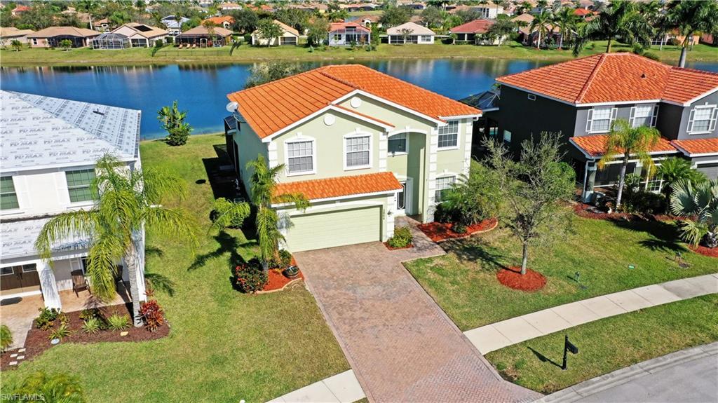 ***PRICE TO STEAL! *** A serene single-family home in a beautiful gated community! Located on a cul-de-sac street providing peace and lots of space for privacy. With an amazing value for over 2600 sq ft. living space, it currently offers the LOWEST PRICED POOL HOME in the neighborhood. This grandiose home presents 4 bedrooms, 3 full baths and a half bath. The generous master bedroom exhibits an on-suite master bath with a soaking tub and a walk-in shower together with an immense walk-in closet and additional office space. The guest room offers an on-suite bath and a walk-in closet that would make even the most particular of guests feel right at home. The vibrant open floor plan also exhibits an oversized kitchen with a breakfast nook, Corian countertops, “42 cabinets and a separate dining room which opens to the family rooms. The extended lanai features a beautifully caged pool overlooking the lakeside. Extensive 2-car garage with a 200 watt plug and is pre-plumbed for a sink. The community offers amenities such as upgraded clubhouse, gym equipment, heated resort style pool and tennis/basketball/ pickleball courts with really low HOA fees! Within walking distance to Publix and CVS.