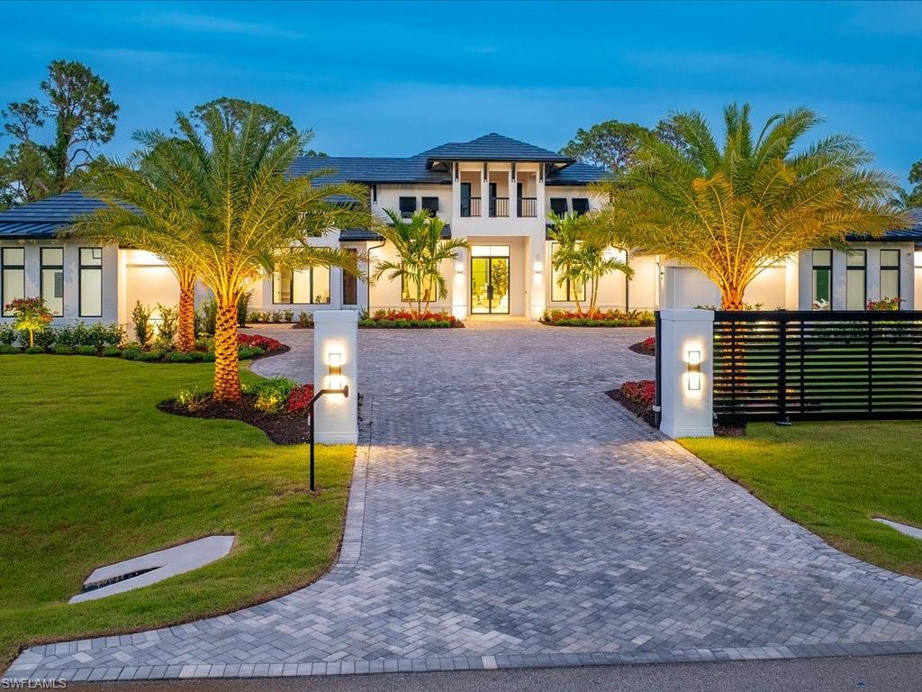 In a market where true distinction is increasingly rare, 500 Ridge Drive presents an extraordinary opportunity to own a private contemporary estate within the prestigious enclave of Pine Ridge. Thoughtfully crafted with nearly six thousand five hundred square feet under air, this architectural showpiece masterfully blends clean modern design with warm organic finishes, creating a residence that feels both sophisticated and deeply inviting. Beyond its lushly landscaped approach, the home unfolds into expansive interiors designed for elevated everyday living and unforgettable entertaining. Five spacious bedrooms, a private office, dedicated home gym, and a versatile bonus room provide exceptional flexibility rarely found within a single residence. At the heart of the home, the remarkable white oak kitchen serves as both a functional centerpiece and design statement, featuring exquisite natural stone surfaces alongside a premier suite of Wolf, Sub-Zero, and Miele appliances. The seamless open-concept layout allows the kitchen, dining, and living spaces to flow effortlessly together beneath rich wood tones and refined contemporary detailing. The primary suite offers a tranquil retreat with bespoke closet systems and spa-inspired finishes that evoke the ambiance of a luxury resort. Whole-home automation enhances the experience with effortless convenience, while every space has been curated with an uncompromising attention to craftsmanship and comfort. Equally compelling, the outdoor living experience rivals that of a private boutique retreat. The expansive covered lanai showcases a dramatic outdoor fireplace, sunken fire bowl gathering space, and beautifully integrated entertaining areas surrounded by mature tropical landscaping that provides exceptional privacy. With a four-car garage, striking architectural presence, and one of Naples’ most sought-after locations, 500 Ridge Drive represents a rare offering where design, lifestyle, and location converge in a way that is seldom available and impossible to replicate.