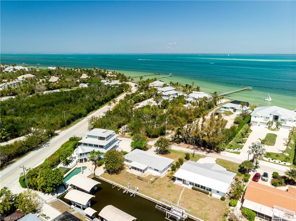 Well-maintained and beautifully updated island bungalow located on the desirable north tip of Pine Island. This charming canal-front home features 2 bedrooms and 2 full bathrooms, offering both comfort and coastal appeal. The property had new roof installed in 2025, equipped with hurricane-impact windows and doors, along with new tile flooring throughout. New  garage door and opener installed in 2026. The bright, open kitchen creates an inviting space for cooking and entertaining. A south-facing screened porch provides the perfect spot to relax and enjoy the island breeze year-round. Additional conveniences include a washer and dryer located in the garage on a separate septic system. The home sustained minimal impact from Hurricane Ian—limited to porch screens—with no flooding or water intrusion. Also minimal water intrusion from Helene and Milton. Being sold partially furnished, this move-in-ready home is ideal as a full-time residence, vacation getaway, or investment opportunity.