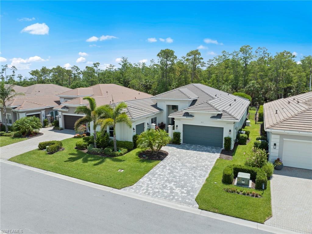 Experience luxury living in this exquisitely upgraded 4-bedroom, 3.5-bathroom Carlyle in Bonita Springs most luxurious 55+ community, Valencia Bonita. Offering 3,102 square feet of elegant interior space, this residence is filled with thoughtful, high-end enhancements throughout.

The impressive exterior features upgraded front and lanai lighting, with a custom fixtures, Storm Smart hurricane protection, and a Generac whole-home generator for peace of mind. The extended lanai is an entertainer’s dream with a full outdoor kitchen, 65” TV, pool and spa, fenced yard, and picture window screen enclosure overlooking a lush Eastern facing Preserve view. 

Inside, sophistication meets function with crown molding, fresh designer paint, rich dark gray doors, and daylight LED lighting. The gourmet kitchen includes GE appliances, a designer backsplash, and upgraded lighting, while the great room showcases a detailed custom ceiling, upscale fixtures, built-in entertainment wall, electric fireplace, and 75” TV. A stylish wet bar with a wine fridge and custom finishes complements the coffered-ceiling dining room and wine cabinet.

The primary suite is a private retreat with blackout power shades, coffered ceilings, dual triple-decked closets, upgraded carpet, and a spa-like bath featuring a sliding barn door, upgraded fixtures, and roll-out shelving. The office/4th bedroom is fully outfitted with a closet, TV, accent wall, motorized shades, and ceiling fan. Each guest room showcases custom ceiling details, TVs, power-shaded windows, and elegant finishes. Both guest baths are equally refined with upgraded faucets, wallpaper accents, and pull-out cabinetry.

Additional highlights include an epoxy-coated garage with built-in storage and an extra fridge, a well-appointed laundry room with custom built-ins, Samsung appliances, and countless designer upgrades inside and out.