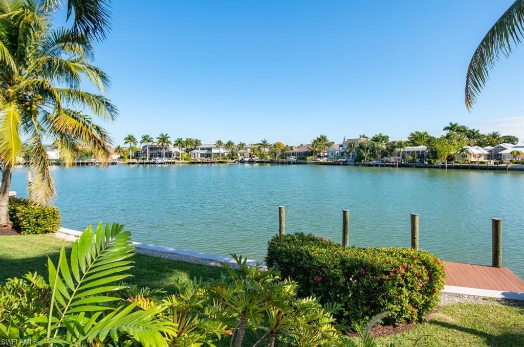 Enjoy unbelievable water views with 106' on Moorings Bay from this custom built estate home.  The main house and cabana house all open onto an expansive pool with multiple water features.   Gracious over sized rooms throughout the home make for easy entertaining and enjoyment.  Beautifully appointed custom details like the marble fireplace, stain glass window and handcrafted iron work in the front gates and balconies embellish the home. This home is truly the epitome of grandeur and the Naples lifestyle.  Tucked on a quiet street in the Moorings, you are less than a few minutes from multiple beach accesses, Venetian Village, Waterside shops and the private Moorings Beach Park.  One will not be disappointed with the quality of this home.