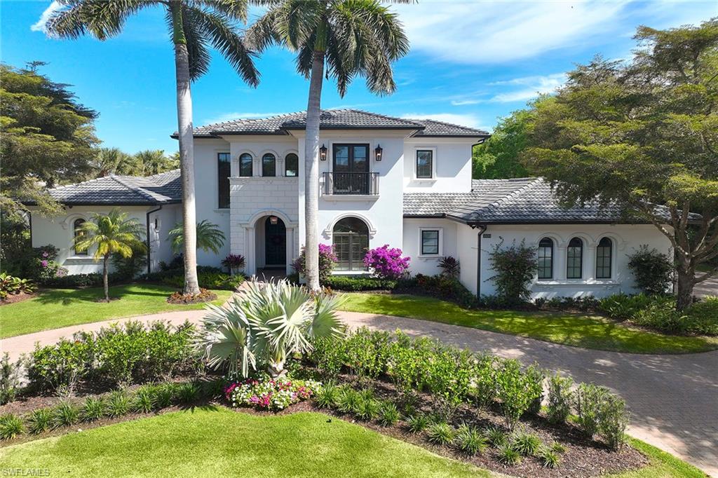 On a private, nearly half-acre end homesite in the prestigious Estates neighborhood of Grey Oaks Country Club, this elegant residence offers refined living in one of Naples sought-after communities. The home features four bedrooms plus a private study, with neutral stone and wood flooring throughout and exquisite ceiling details enhancing nearly every room. A grand mahogany entry door opens to soaring ceilings, a striking gas fireplace with stone surround and a large picture window that fills the living space with natural light. The living room flows effortlessly into a formal dining room with French doors overlooking the side yard, creating an ideal setting for entertaining. The remodeled kitchen is a showpiece, boasting white cabinetry, quartz countertops and new appliances, all opening to a spacious family room. Go outside to a large, private backyard with ample room for a new custom pool. The covered lanai provides the ideal space for alfresco dining or relaxing while enjoying Naples mild winter climate. The primary suite is a serene retreat, featuring newer wood flooring, dual vanities, a soaking tub and two custom walk-in closets. Two guest suites upstairs and an additional suite on the main level, each with its full bath, offer comfort and privacy for family and visitors alike. Additional highlights include a private study with a fireplace, coffered ceiling and built-in bookshelves, a three-car climate-controlled garage, new roof and landscaping, and a separate laundry room. Experience the ultimate in luxury living at Grey Oaks Country Club, where residents enjoy three championship golf courses, world-class amenities, and proximity to Naples renowned dining, shopping and pristine white sand beaches.
