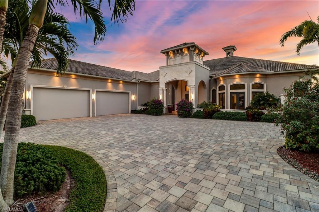 Elevate your lifestyle in this exceptional home within the exclusive enclave of Venezia Grande Estates. Thoughtful design and exquisite, custom finishes combine to create a sophisticated, contemporary space…comfortable for everyday living and ideal for entertaining. The master suite has a sitting area, coffee bar, and two walk-in closets. Each guest bedroom is ensuite. All bathrooms have custom vanities & lighting, plus full-sized linen closets. European cabinetry, large work island, quartz tops plus Miele, Thermador & Wolf brand appliances define the kitchen. The outdoor living space is a tropical oasis with view of swaying palms, lake & fountains. Refresh in the Infinity edge pool, relax in the sun or by the fire pit and revive with a meal cooked in the fully outfitted outdoor kitchen cabana that includes a charcoal Brazilian grill. Car enthusiasts will love the air-conditioned 4-car garage designed to accommodate hydraulic lifts for an ultimate 8-car capacity. Quality is evident from the high security, pivoting front door, hidden-hinge interior doors with magnetic closures, and Graff faucets & fixtures throughout. Seeking a home with uncompromising value…This home nails it!