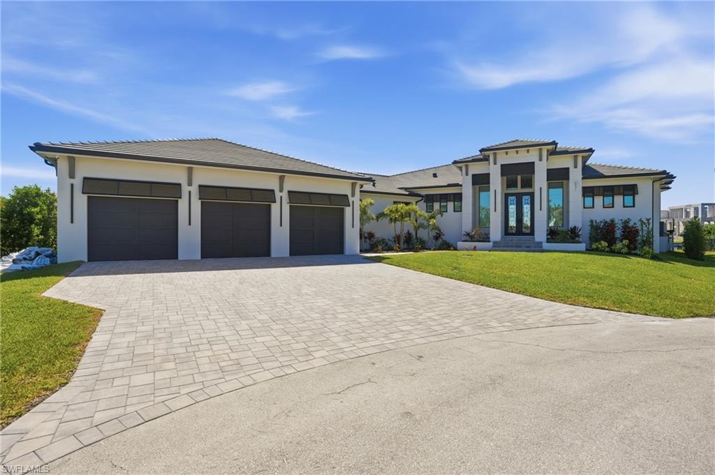 ULTIMATE GULF ACCESS MASTERPIECE WITH INTERSECTING CANAL VIEWS
Experience unmatched luxury in this custom 5-bedroom contemporary estate, perfectly positioned on an oversized corner lot with sweeping intersecting canal views. Designed for the serious boater and modern entertainer, this home offers direct Gulf access and a private waterfront oasis featuring a massive wraparound composite dock, a 40,000 lb boat lift with canopy, and an additional 12,000 lb lift.
The open-concept floor plan is anchored by a breathtaking great room with soaring tray ceilings and a floor-to-ceiling iconic fireplace. The chef’s kitchen is a true showpiece, featuring quartz countertops, Thermador appliances, and a secondary scullery prep pantry with a full kitchen for effortless entertaining.
Additional highlights include an oversized 4-car garage with epoxy floors, a whole-home Generac generator, and a designer laundry suite equipped with three sets of high-efficiency machines.
Pocketing sliders open to a massive screened lanai with tongue-and-groove tray ceiling accents, a resort-style heated pool and spa, outdoor shower, and stunning outdoor fireplace. The outdoor living space is elevated by a full summer kitchen with professional vent hood, gas grill, and waterfall granite prep island.
The master retreat offers a spa-like bath with a vessel trough sink, mosaic feature wall, and LED mirrors. Tiered paver steps lead to your private dock, perfectly situated for quick river access.
From the striking iron-and-glass double entry doors to the impact-rated windows and premium hand-selected finishes, every square inch of this home reflects the pinnacle of modern Florida waterfront living.