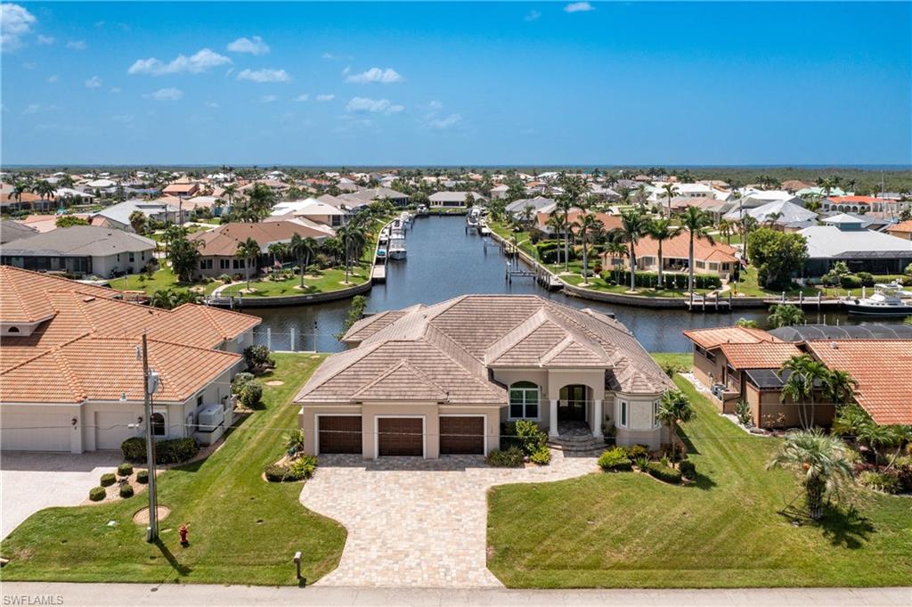 *Punta Gorda Isles~*South Facing, Spectacular Expansive Intersecting Canal Views *QUICK Direct Sail Access to Charlotte Harbor! *Refined and Elegant ~ Custom Built 3 Bedroom, 3 Full Bath Plus Office, Pool Home has been Crafted by West Coast Builders! *4316 Total Sqft *Pass Through the 16 Ft Glass Disappearing Pocket Sliders onto an Extensive Lanai offering A large Seating Area, A Relaxing Full Wall Fireplace, Outdoor Kitchen, And A Waterfall Tiled Pool *95 ft of City Maintained Seawalls *10k Boat Lift *Interior and Exterior Wall Sculptures and Ceiling Artistry by Well-Known Artist Diane Kole *4 CAR GARAGE *Interior ~ *Solid Wood Cabinetry *Granite Counters *Transient Windows *Tray Ceilings *Double Tray Ceiling *Ceramic Tile Throughout *An abundance of Storage *Central Vac *Water Softener *Oversized Utility room *Wet Bar * Pool Bath *!0 Ft Doors *Such a Fantastic Location for This Gorgeous Home! Now's the Time to Make It Yours! Be Sure to View The Video!