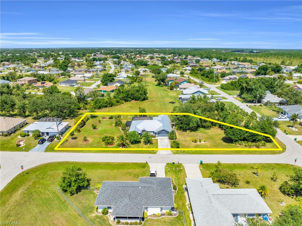 RARE OPPORTUNITY for a beautiful POOL HOME on 0.68 ACRES in Deep Creek!! Set on a CORNER TRIPLE LOT with stunning greenbelt views and western rear exposure, this home offers space, privacy, and Florida living at its best. The sparkling pool is surrounded by an expansive lanai with an additional deck area, and three sets of sliders create an easy flow between indoor and outdoor spaces. Inside, vaulted ceilings add volume to a flexible floor plan with two living areas and two dining areas. The spacious primary bedroom features two walk-in closets and an en-suite bath with dual vanities, a soaking tub, and a separate shower. The second bath doubles as a pool bath, and the large laundry room includes a sink for added convenience. An attached shed offers versatile bonus space, ideal as a "she-shed", workshop, hobby room, or simply extra storage. Major updates are already in place, including a NEWER METAL ROOF and newer A/C system, and Bahama shutters add both charm and protection. Located outside the flood zone with NO FLOOD INSURANCE REQUIRED, this Deep Creek home is just minutes from I-75, shopping, and dining. Oversized lots with this much privacy rarely come available, and this one is ready for its next owner!