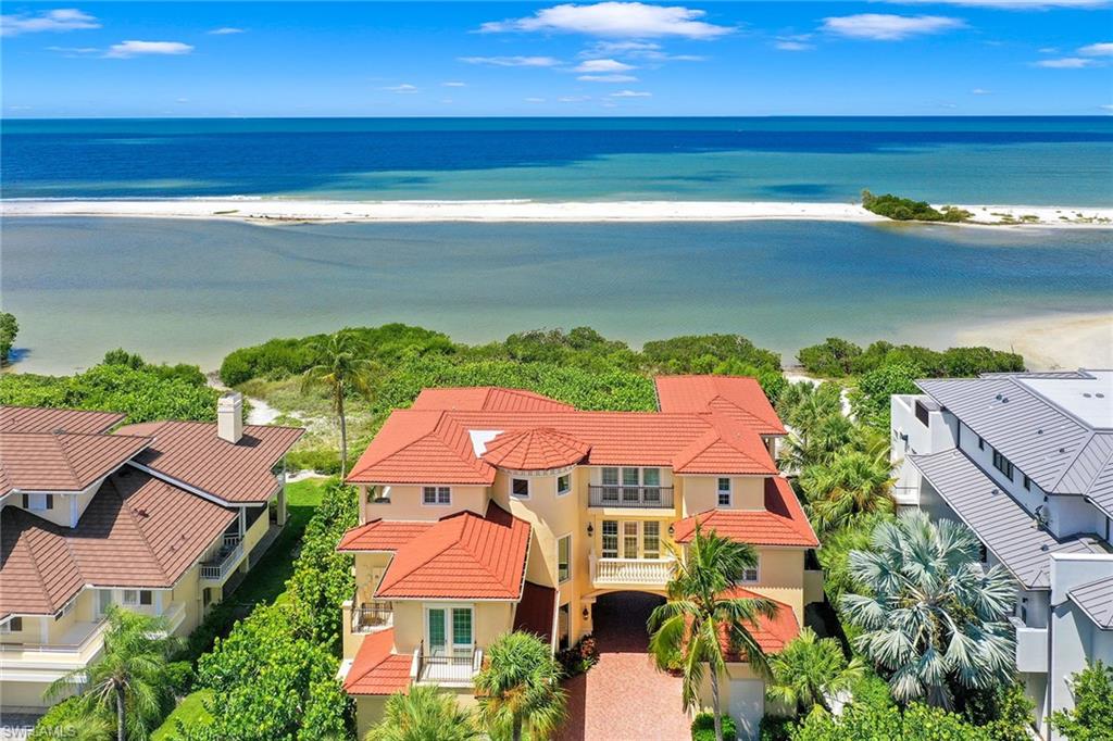 A breathtaking Architectural Masterpiece sitting on the Gulf of Mexico with unequivocal western Gulf and beach views! Boasting over 4690 SF under air, and approximately 9618 total SF of unsurpassed quality and wood craftsmanship throughout.  Never miss another sunset from one of eight beachfront terraces with endless views! Perfection at its finest with 3 living levels complete with elevator and dramatic sweeping staircase. Open concept Great room with 15' ceilings and transom windows all open to Gulf and Beach. Open gourmet kitchen with double wall ovens, stainless steel appliances, granite counters and breakfast bar. Family room on second floor comprises of sunrise and sunset balconies. Third floor entertaining room with absolutely stunning views complete with wet bar for entertaining. Beautiful bamboo and tile flooring throughout. This resort style residence has 4 bedrooms and 4 full baths, room for the whole family to enjoy this legacy property. 3 brand new Air Conditioners put in this year! Located in Prestigious 24 hr. gated community on the Gulf of Mexico with world class amenities. Built for the most discerning buyer, you will not be disappointed.