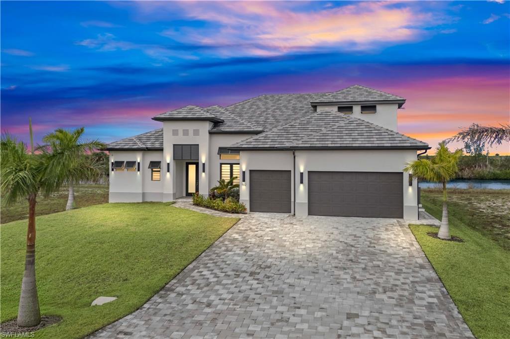 Welcome to this extraordinary new construction Gulf access pool and spa home, located on the spreader canal in Cape Coral, Florida. This 4-bedroom,5-bathroom residence offers the perfect blend of luxury, style, and coastal living, making it the ideal home for those seeking the ultimate waterfront lifestyle. As you approach, the modern architectural design and clean lines immediately create curb appeal. The exterior showcases tropical landscaping, a paver brick driveway, and a grand entryway, setting the tone for the upscale features waiting inside. Step through the front door into an expansive open-concept living area that blends style and function seamlessly. The living room features large impact-resistant sliding glass doors that flood the space with natural light, creating a bright and airy atmosphere while offering breathtaking views of the pool, spa, and canal. With high ceilings and an inviting ambiance, this space is perfect for entertaining guests or enjoying a relaxing evening at home. At the heart of this home is the gourmet kitchen, designed for both casual cooks and culinary enthusiasts. It boasts top-of-the-line stainless steel appliances, custom cabinetry, and elegant quartz countertops. The large center island offers ample workspace and seating, making it ideal for casual dining or hosting social gatherings. Whether preparing meals for a dinner party or enjoying a quiet breakfast,
the kitchen’s functionality and aesthetic appeal will impress. For those who love outdoor living, the lanai area and summer kitchen is a true highlight of the home. Pocketing 90-degree sliding doors open to reveal a vast outdoor space, designed for relaxation and entertaining. The sparkling pool with a built-in spa invites you to bask in the Florida sunshine or enjoy a refreshing dip. The pool area is surrounded by lush landscaping and offers tranquil canal views, creating the perfect outdoor oasis for lounging, dining al fresco, or simply unwinding. With Gulf
access from the canal, boating enthusiasts will love the convenience of heading out on the water at a moment’s notice. Back inside, the luxurious master suite offers a private sanctuary. Large windows provide picturesque views of the canal, creating a peaceful retreat where you can relax and recharge. The en-suite bathroom is spa-like, featuring a large walk-in shower, dual vanities, and designer finishes throughout. The spacious walk-in closet offers ample storage for all your needs. The home’s split-bedroom layout ensures privacy for all. Three additional
generously sized bedrooms two come with their own well-appointed bathrooms, offering comfort and convenience for family members or guests. In addition to its striking design and luxurious features, this home offers all the advantages of modern construction. Built with energy efficiency in mind, it includes impact-resistant windows and doors, a state-of-the-art HVAC system, and advanced insulation to keep the home comfortable year-round.