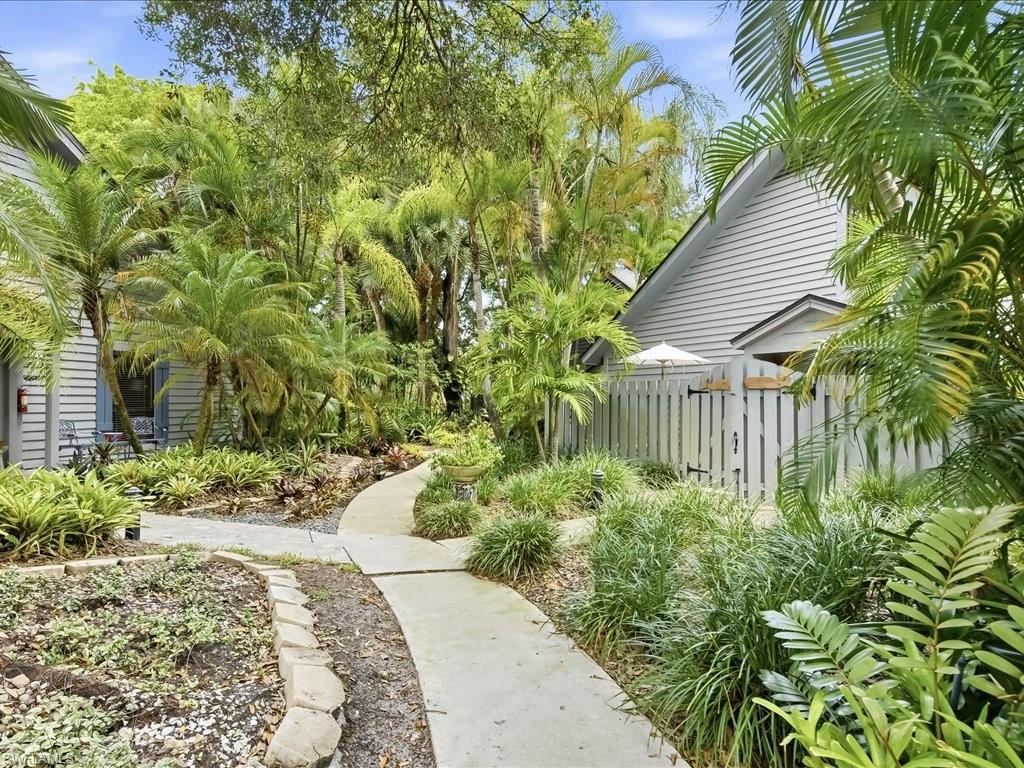 Discover Naples Hidden Gem with an in town location where you will immerse yourself in a quiet botanical garden style tropical environment. This Villa has 2 private patios for relaxation and dining. Step inside this spacious floor plan and discover high vaulted ceilings with an open great room and dining area overlooking the private outdoor brick floor patio. There are 2 primary bedroom options one on the first level or on the second level plus a third bedroom/den on the first level. Bent Pines is a pet friendly neighborhood with a community pool and friendly neighbors. 1.5 miles from Naples gorgeous beaches. 15 minutes from downtown Naples and minutes from shopping and restaurants.