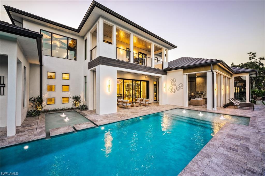 At 691 Annemore Lane, this exquisite estate built by Bonura Custom Homes and featured in Home & Design magazine offers a rare combination of effortless luxury and peace of mind. In the prestigious Pelican Bay community and designed by Stofft Cooney Architects with interiors by Clive Daniel Home, this home presents a grand 27-foot foyer and an elegant open staircase with glass railing. Built outside the flood zone and constructed with safety in mind, the home is equipped with two generators, a 1,000-gallon propane tank, impact windows and motorized hurricane shutters, ensuring comfort through any season. While offering security and reliability, it never compromises on beauty or lifestyle. The chef’s primary kitchen is accompanied by a fully equipped secondary kitchen and walk-in pantry, ideal for entertaining. The formal living and dining rooms surround an award-winning, climate-controlled wine room, showcasing the home’s sophistication. A club room with a wet bar opens to a serene outdoor oasis with a private fire pit, pool, spa and an alfresco grill. The owner’s suite is a private retreat with separate baths, complemented by four additional bedrooms with en suites. Practical amenities include an air-conditioned four-car garage, a secured package delivery room with a refrigerator and an elevator for convenience. The home is designed for a luxurious lifestyle with Pelican Bay’s world-class amenities such as beach clubs, golf, tennis and pickleball just moments away.