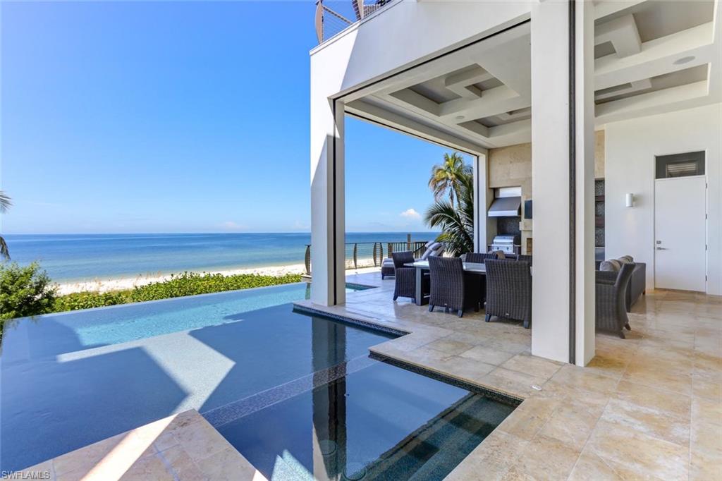 Direct beachfront, recently-constructed home by the renowned Windover Development. Boasts state-of-the-art features & high-end coastal contemporary designer finishes with panoramic Gulf views as the backdrop. Incredible open floor plan with exceptional use of space highlights the beachfront setting, with fully-pocketing sliders that open to the panoramic Gulf views & year-round sunsets. This 6,170 sq ft home includes 5 beds, 5.5 baths, spacious garage & private elevator. Elevated entertainment deck with dramatic infinity edge pool & spa, summer kitchen with gas grill & fireplace, all overlooking the Gulf. No details overlooked with white oak hardwood floors, wood-accented volume ceilings, designer lighting features & all quartz/granite counters. Professional-grade kitchen features Thermador appliances & full-size built-in bar. The master retreat is accented by an exposed wood beam ceiling feature, private beachside balcony, and a spa-like En Suite master bath. Other features include Crestron home automation system, electronic shade and hurricane shutter control, and Vitex security system. This caliber of home is rare and should not be missed.